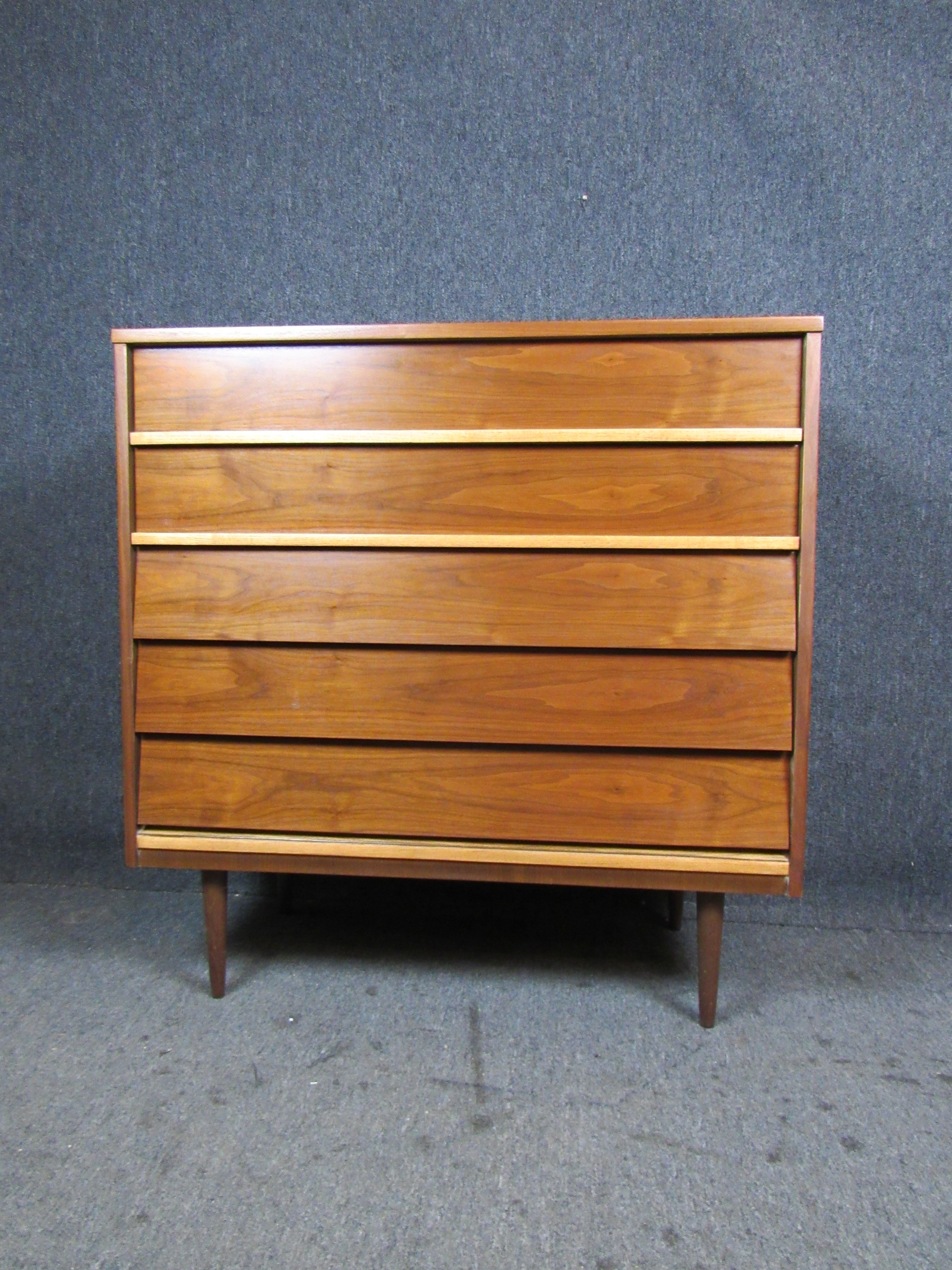 Beautifully refinished midcentury vintage chest of drawers from Lexington, North Carolina's Dixie Furniture Company! With five large, pull-out drawers, this dresser brings together form and function with it's practicality and beautiful appearance.