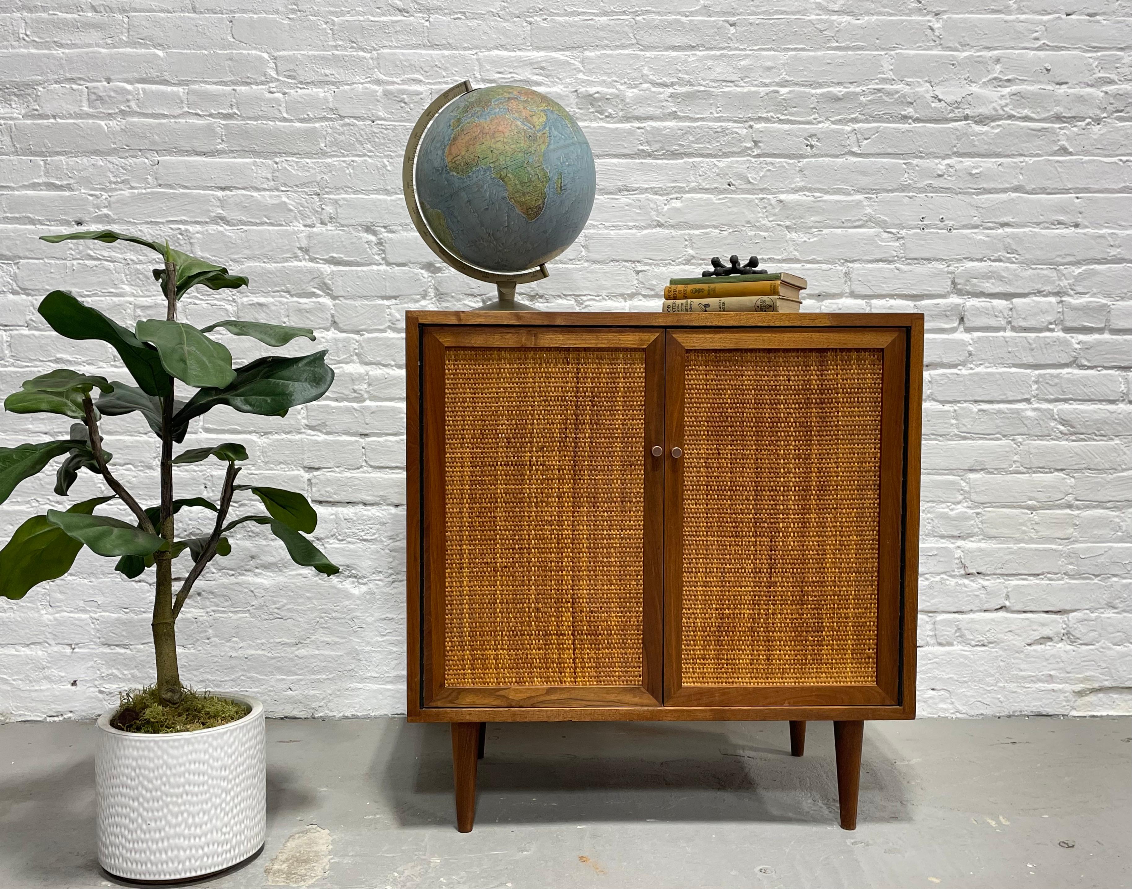 Mid-Century Modern Walnut Jr. Credenza / Vinyl Storage Cabinet, circa 1960s. This beauty features perfect rattan doors that are reversible if you want to switch the look up and have simple outward facing doors. Completely refinished on all sides