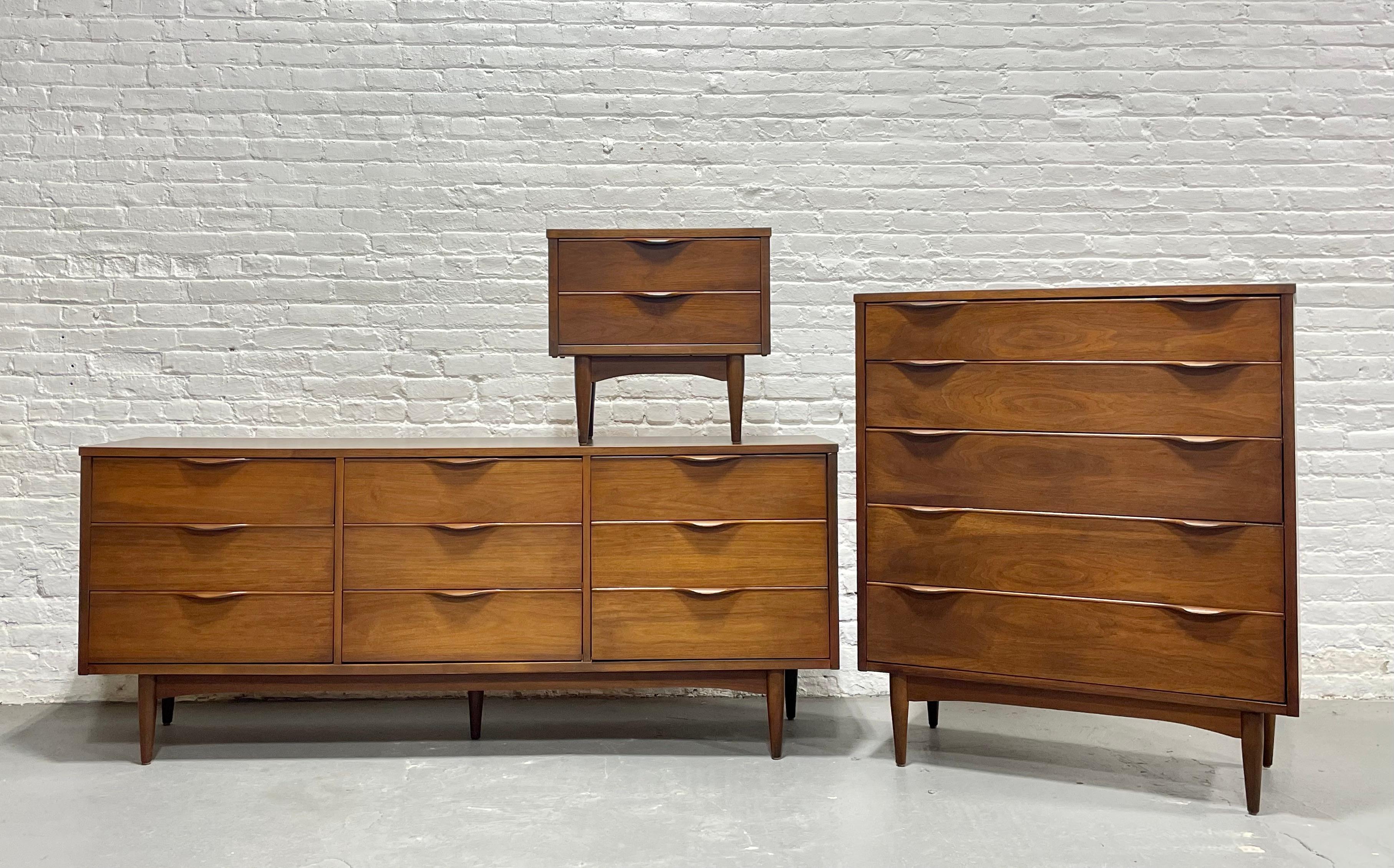 Gorgeous Walnut Mid Century Modern Bedroom Set consisting of a long dresser, highboy and single nightstand, c. 1960's.

Each piece features sculpted hand-pulls, loads of storage space and solid construction. The tabletops are a durable woodgrain
