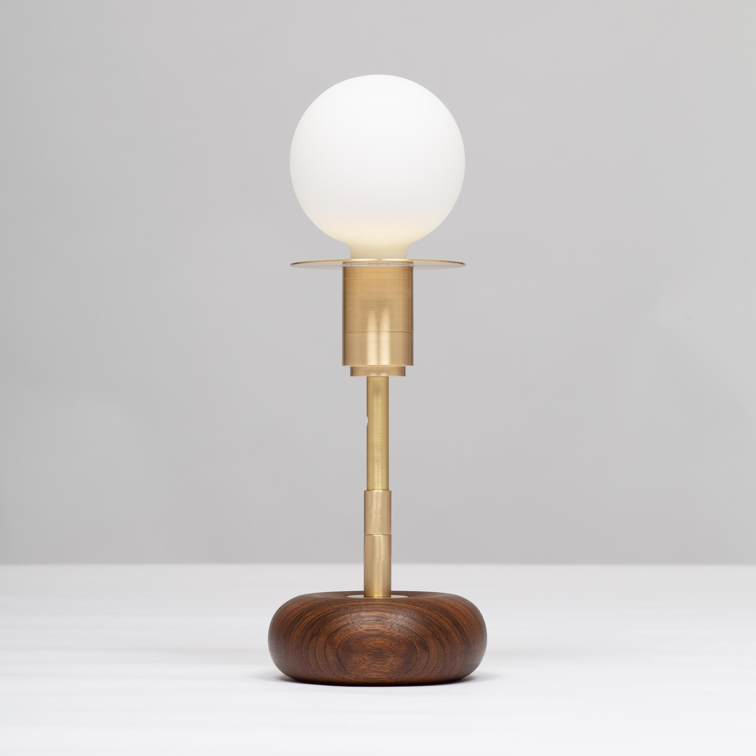 Handturned Walnut Pebble Table Lamp. Pure Monocoat natural oil finish.
Solid brass, Satin finish. Spun Brass Disc. Lacquered. 
Inline LED dimmer. Linen Fabric Cable.
2000K - 2800K  95CRI
600 Dim to Warm Lumens
Sphere III bulb included
Smoke Oak,