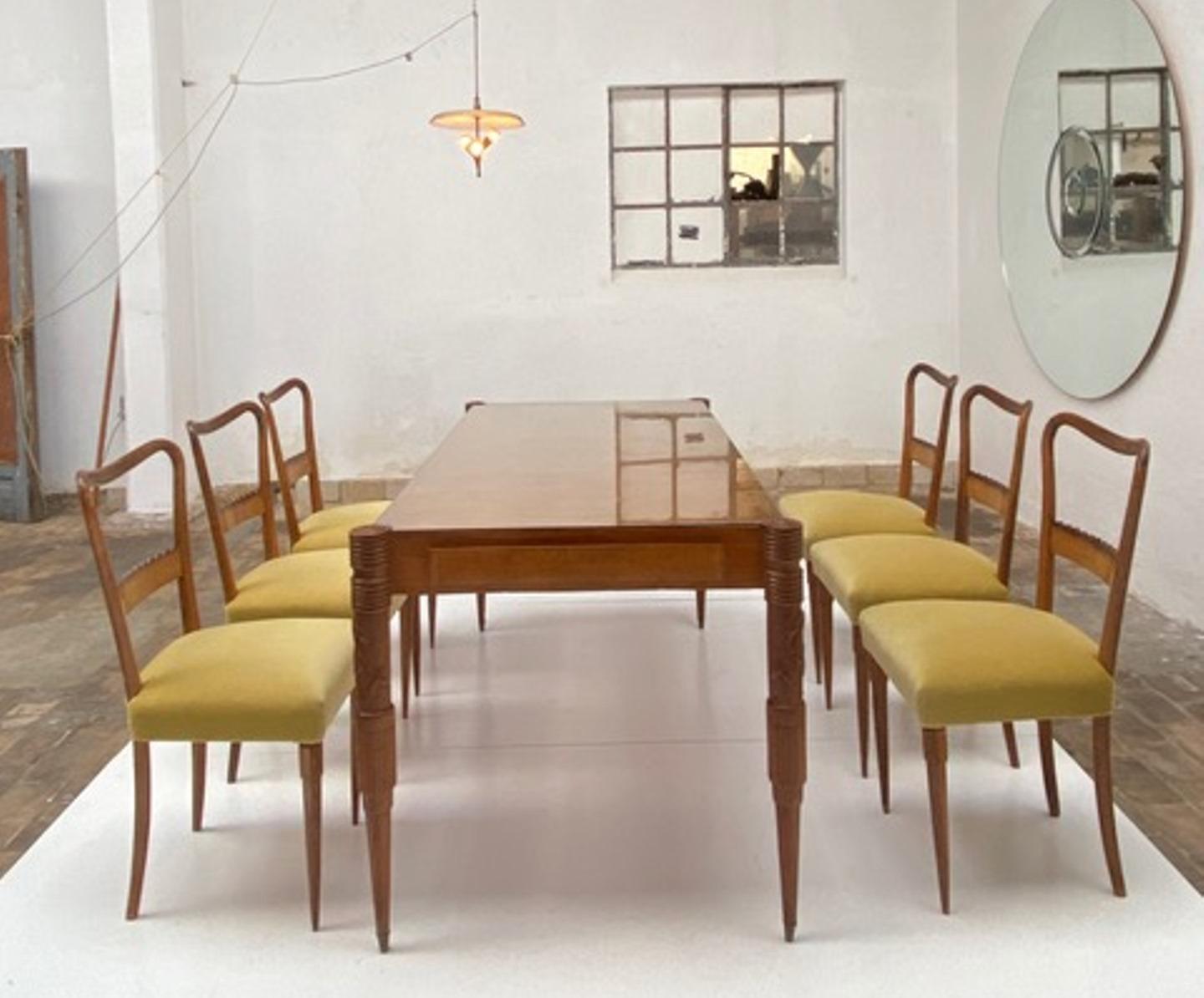 Stunning walnut dining table and six matching dining chairs by Pier Luigi Colli, handmade by the famed 'Fratelli Marelli' atelier in Cantu, Italy circa 1950. 

The dining table is finished in solid and veneered italian walnut with a protective