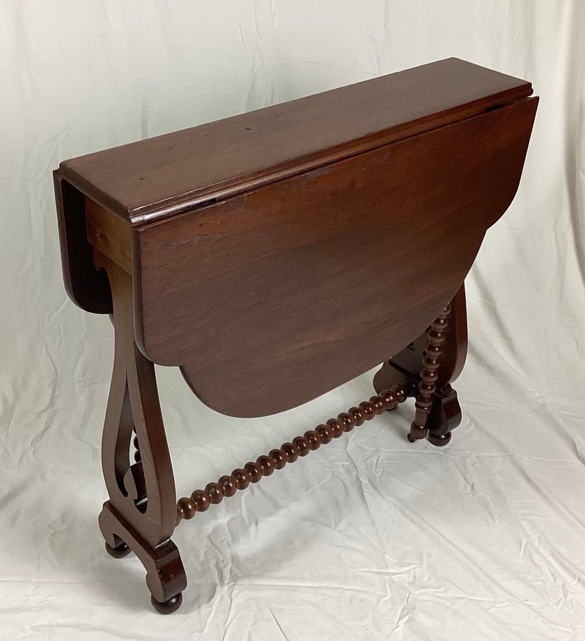 Walnut narrow small tuck-a-way drop leaf table with Barley Twist Legs. Closed it is only 8