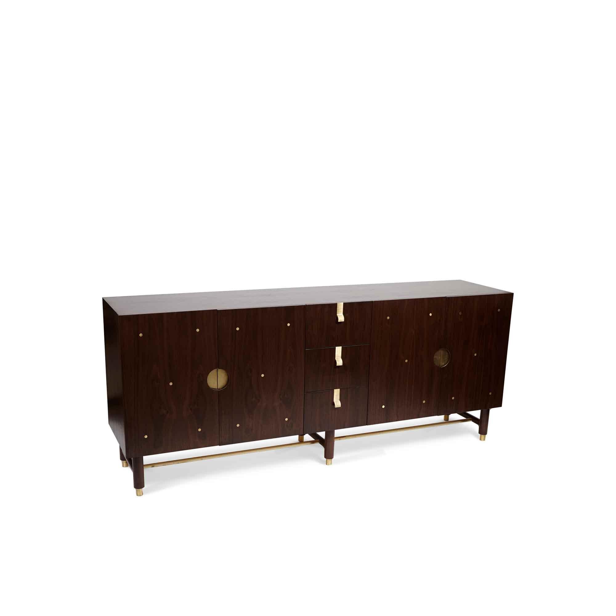 The Niguel Cabinet by Lawson-Fenning has a brass stretcher on the base, brass inlaid details on the doors, and insert brass handles. The interior is lacquered. 

The Lawson-Fenning Collection is designed and handmade in Los Angeles, California.
