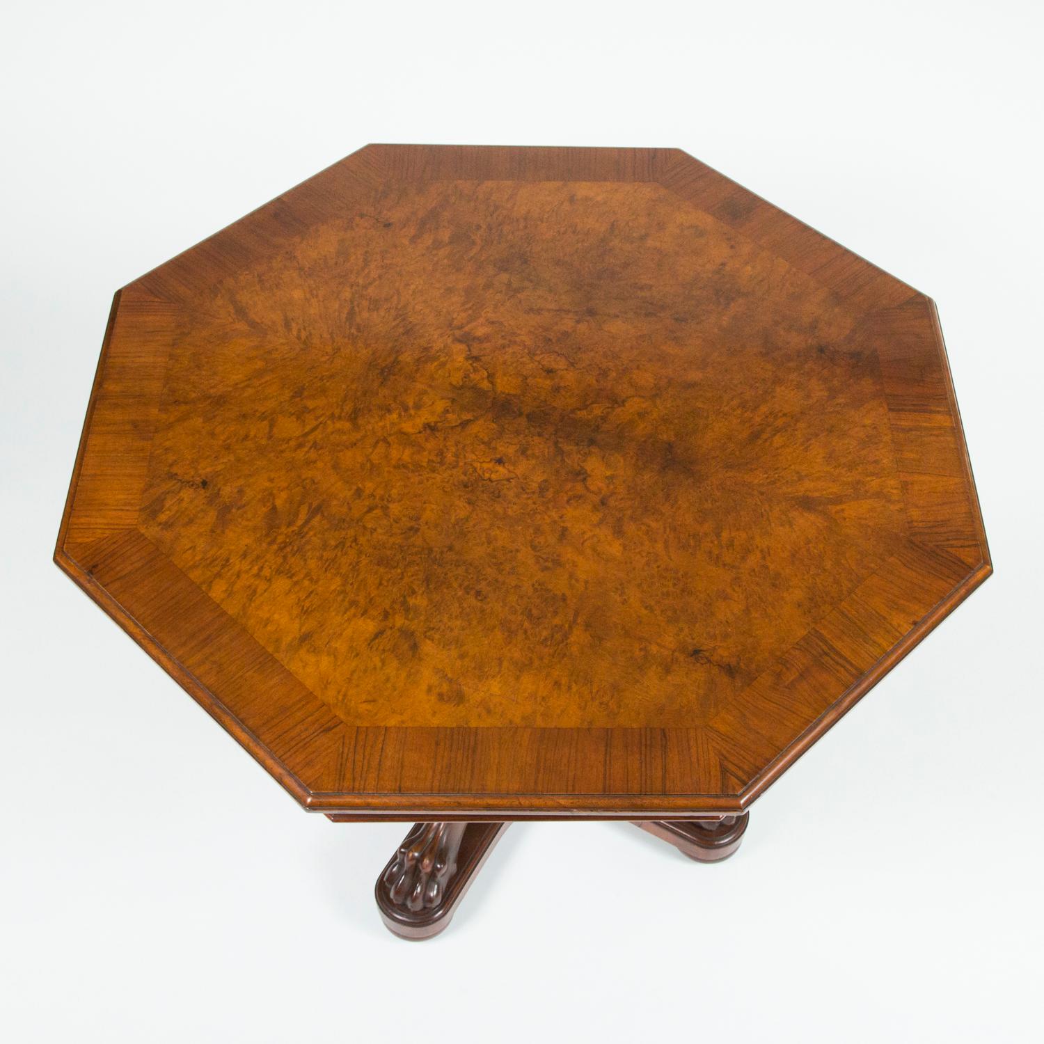 A fine quality late 19th century walnut octagonal center table, a very well carved central stem with acanthus and paw feet.