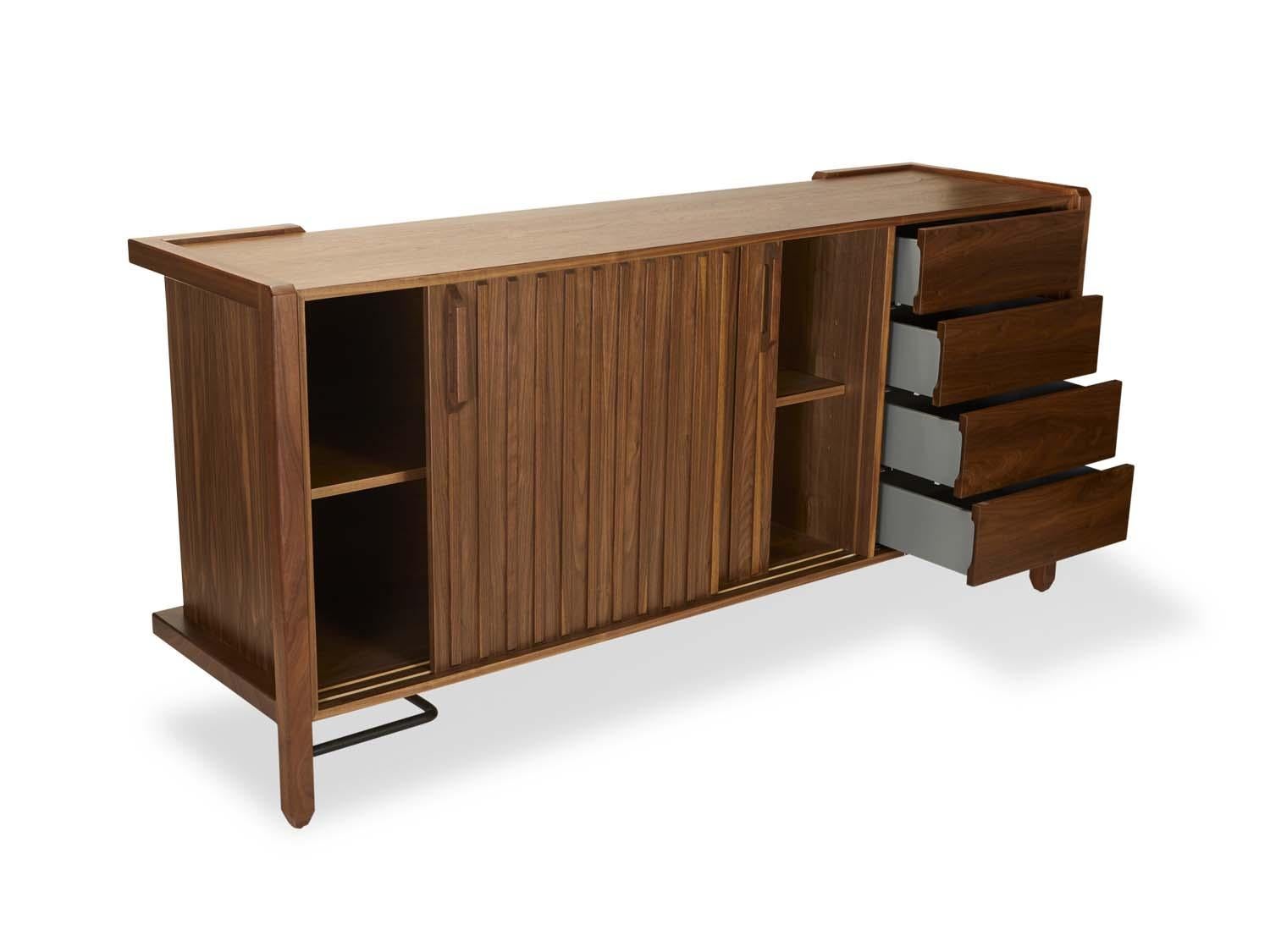 Walnut Ojai Credenza by Lawson-Fenning. The Ojai credenza has four drawers and two bypass doors with open storage behind it. It has solid white oak or American walnut legs and case, and features a metal stretcher on the base.

The Lawson-Fenning