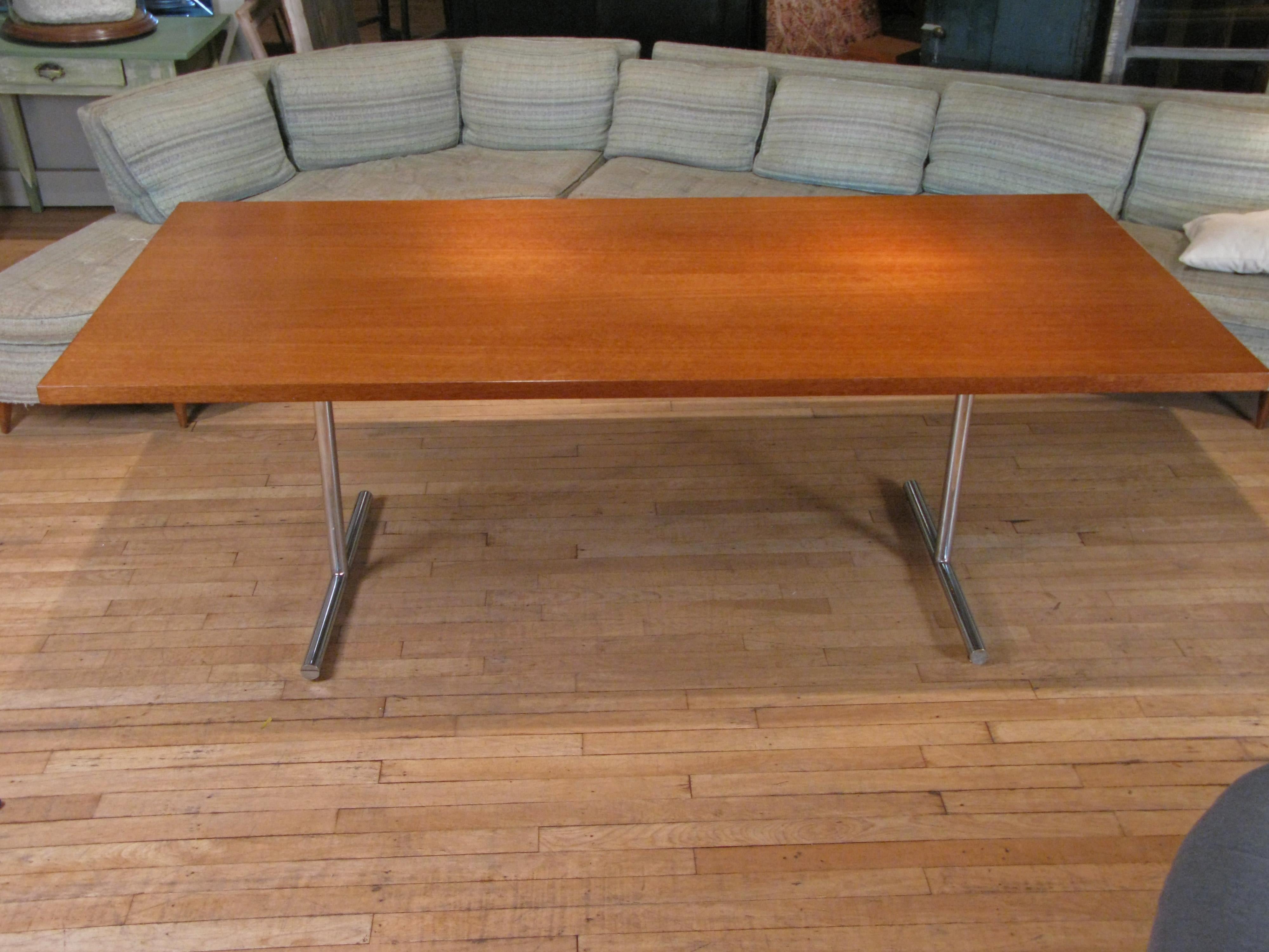 A beautiful and handsome 1950s 'Omega' dining table or desk designed by Hans Eichenberger and made by Hausmann & Hausmann in Switzerland. A modern spare design, with a large walnut top supported by a thick chromed steel base.

Works equally well