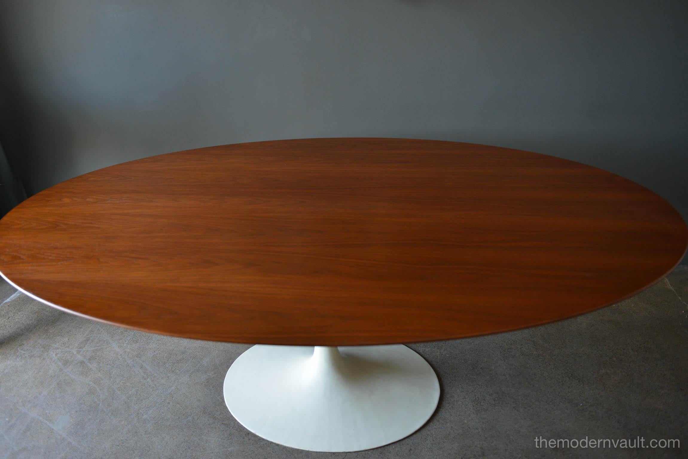 Rare early Eero Saarinen for Knoll Associates oval walnut tulip table. tabletop has been professionally restored in showroom condition. Base is solid cast iron, not hollow, indicating an early model circa 1960. Beautiful lines, sourced from a one