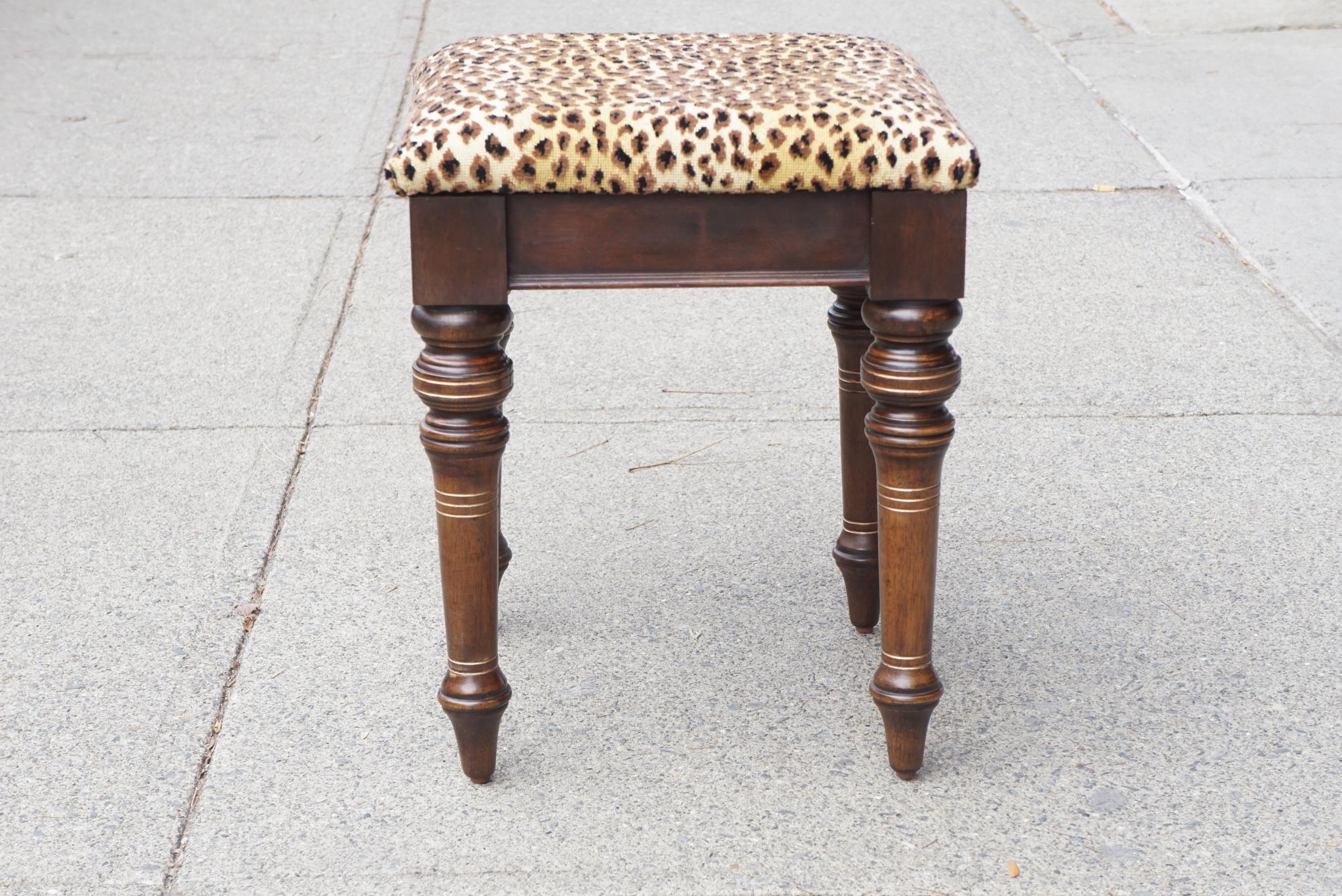 This walnut carved and turned footstool was made circa 1875 in the Aesthetic Movement style. Most likely made in America the stool is of a chunky robust proportion with large turned legs and deeply incised lines that have been gilded giving the