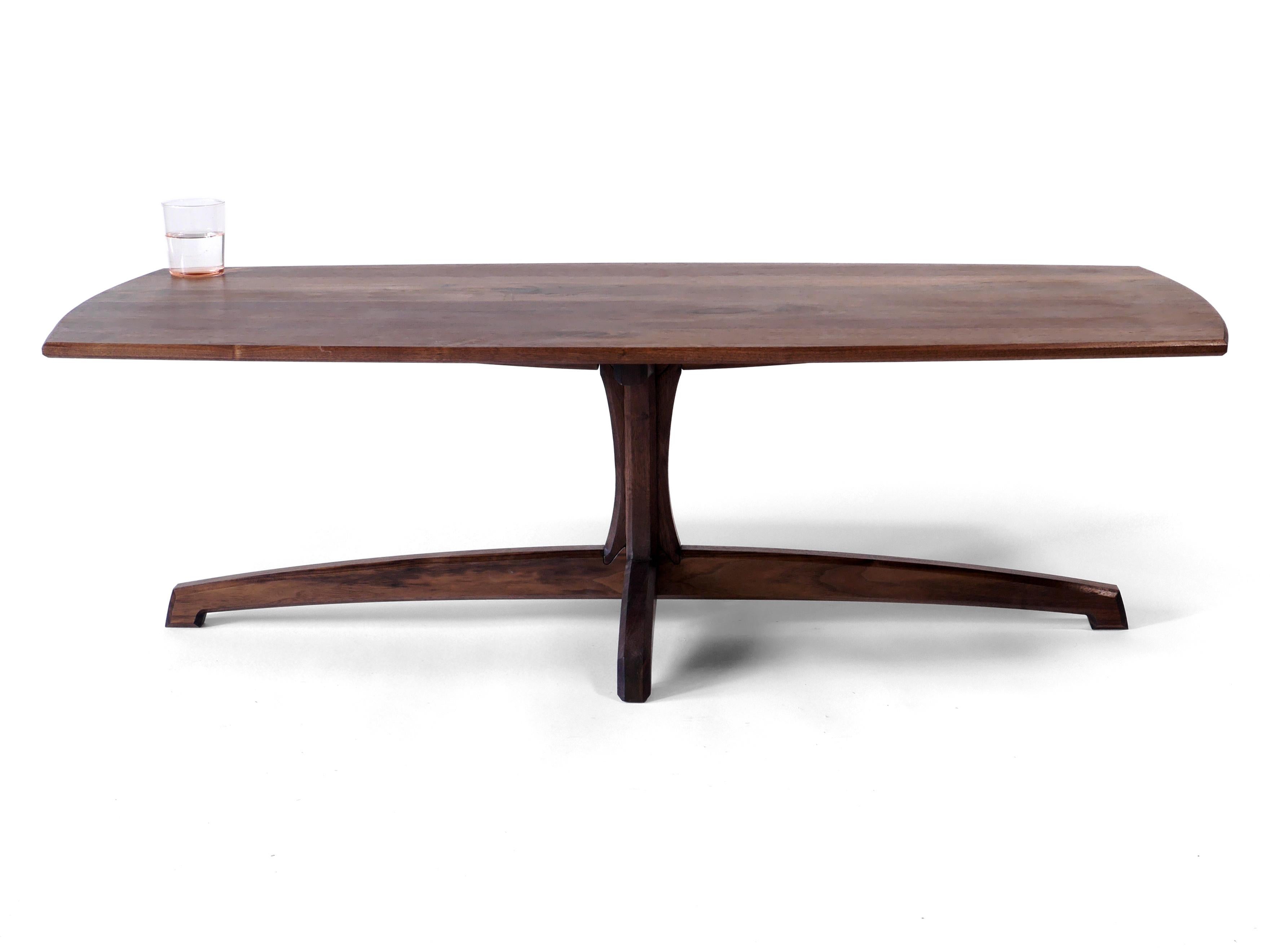 This beautiful Plume Ccoffee table is made out of solid black walnut hardwood and has a detail rich grace highlighted by its simplicity. Each piece is built to order one at a time by master craftspeople in our shop in Albuquerque, NM, and assembled