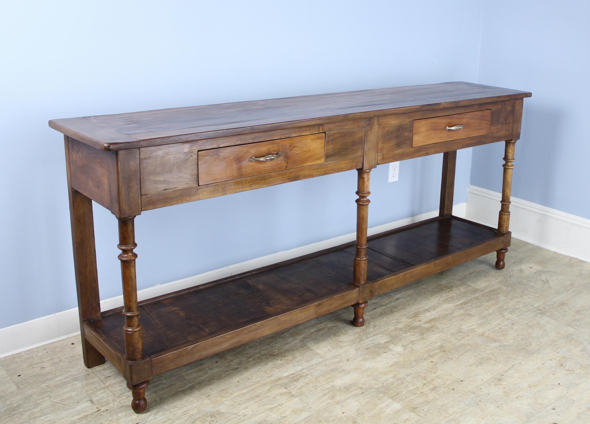 A lovely walnut potboard server, custom made for Briggs House in France with old legs, circa 1850. Generously proportioned with a thick top, two roomy drawers, and vivid walnut color.