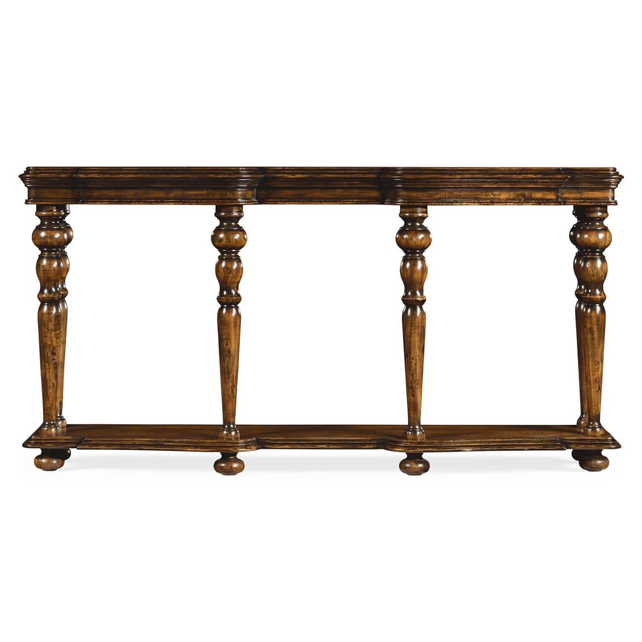 A distressed carved walnut six-legged console table with a molded and shaped top and edge, turned and tapered supports and a shaped shelf stretcher base, all raised on bunn feet.

Dimensions: 72