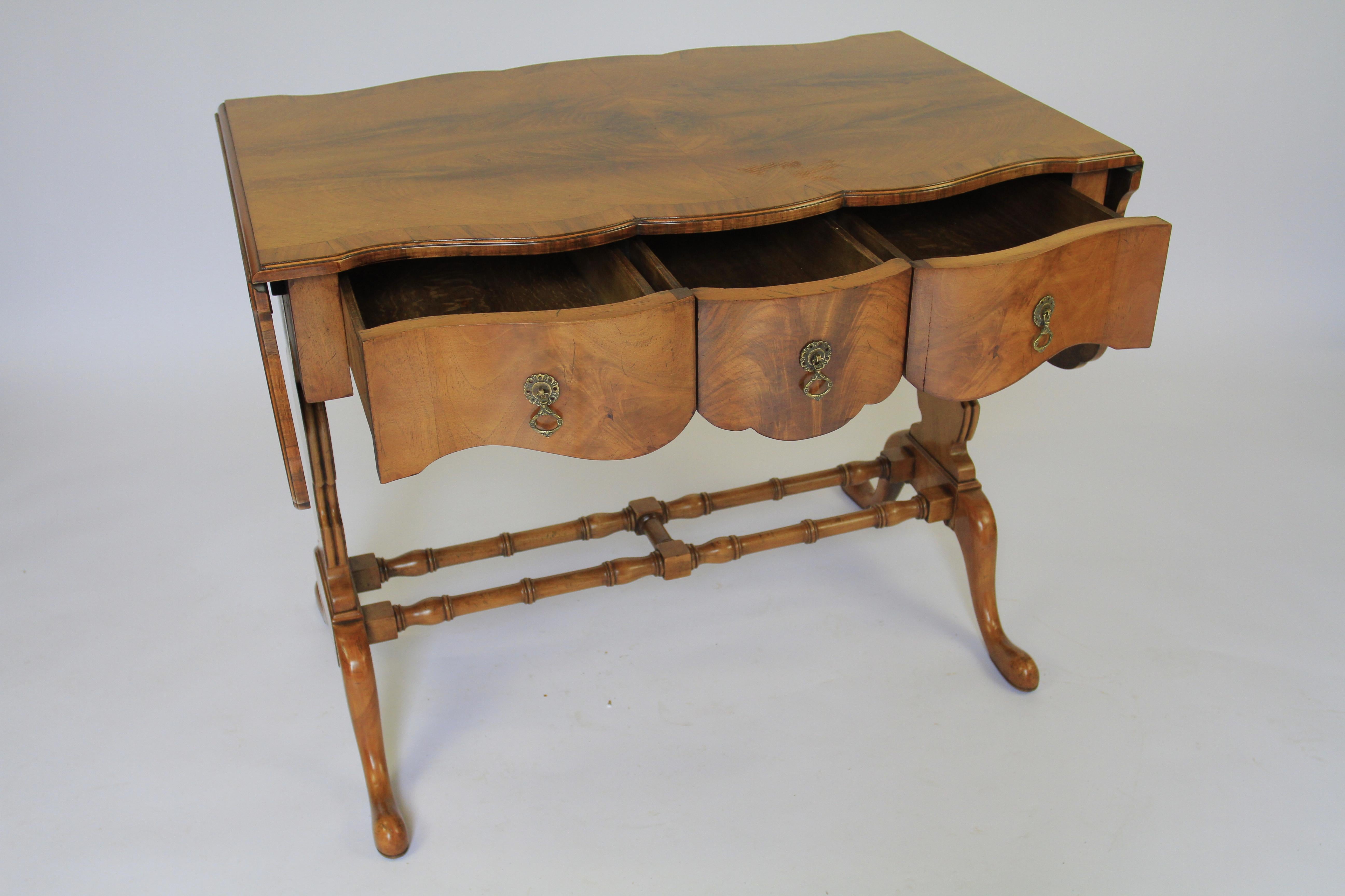 Walnut Queen Anne Style Sofa Table circa 1920s
Good Figured walnut veneer on top, 
Knuckle hinge supports to hold drop leaves
Shaped single drawer at front, oak lined drawer
 shaped walnut back
Walnut Shaped end supports, 
Turned Walnut H shaped