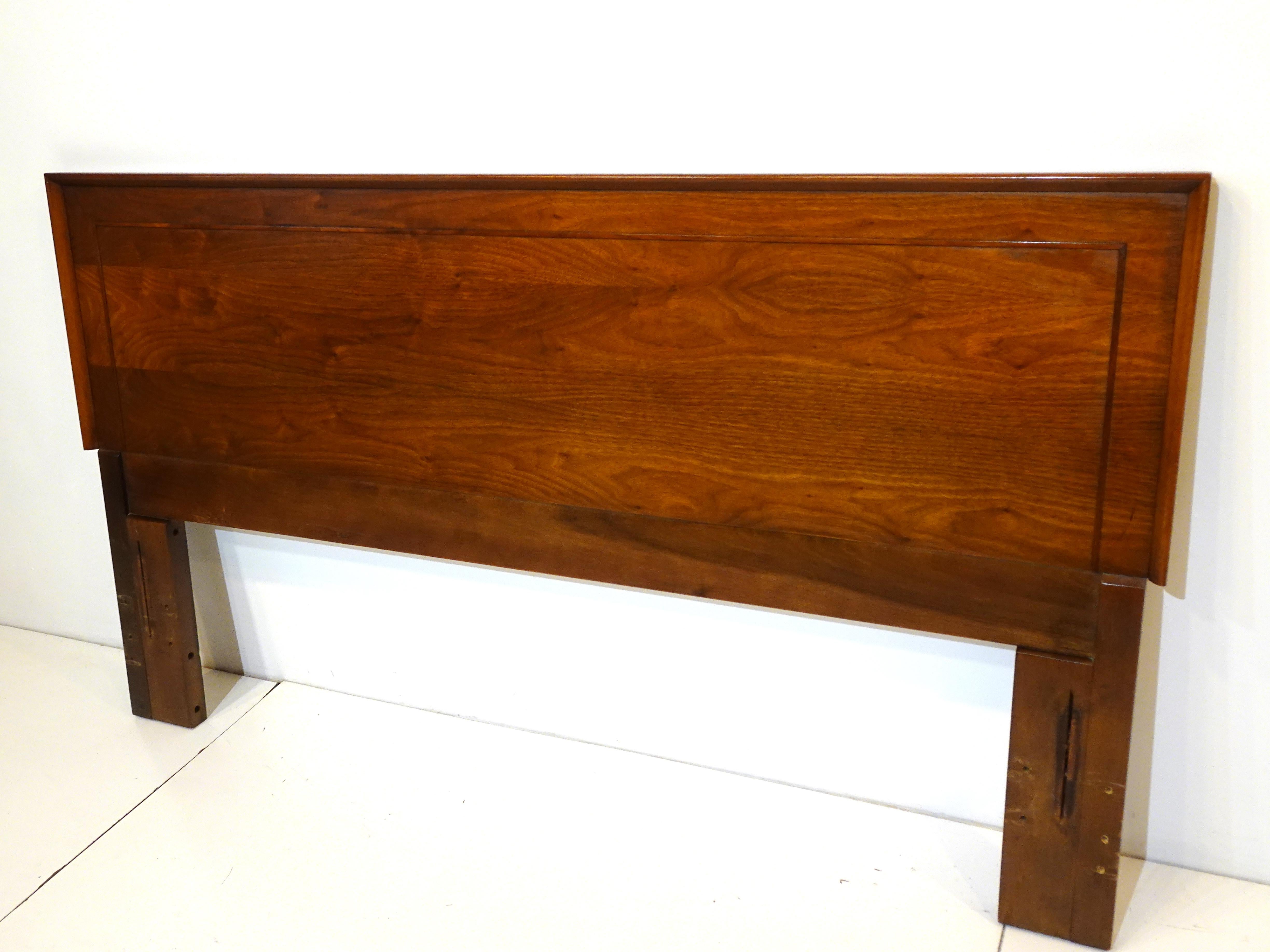 A beautifully grained walnut queen sized headboard with nice wood inter trim detail to the headboard , attaches to your excising mattress frame . Manufactured by the American of Martinsville Furniture company designed by Merton Gershun .