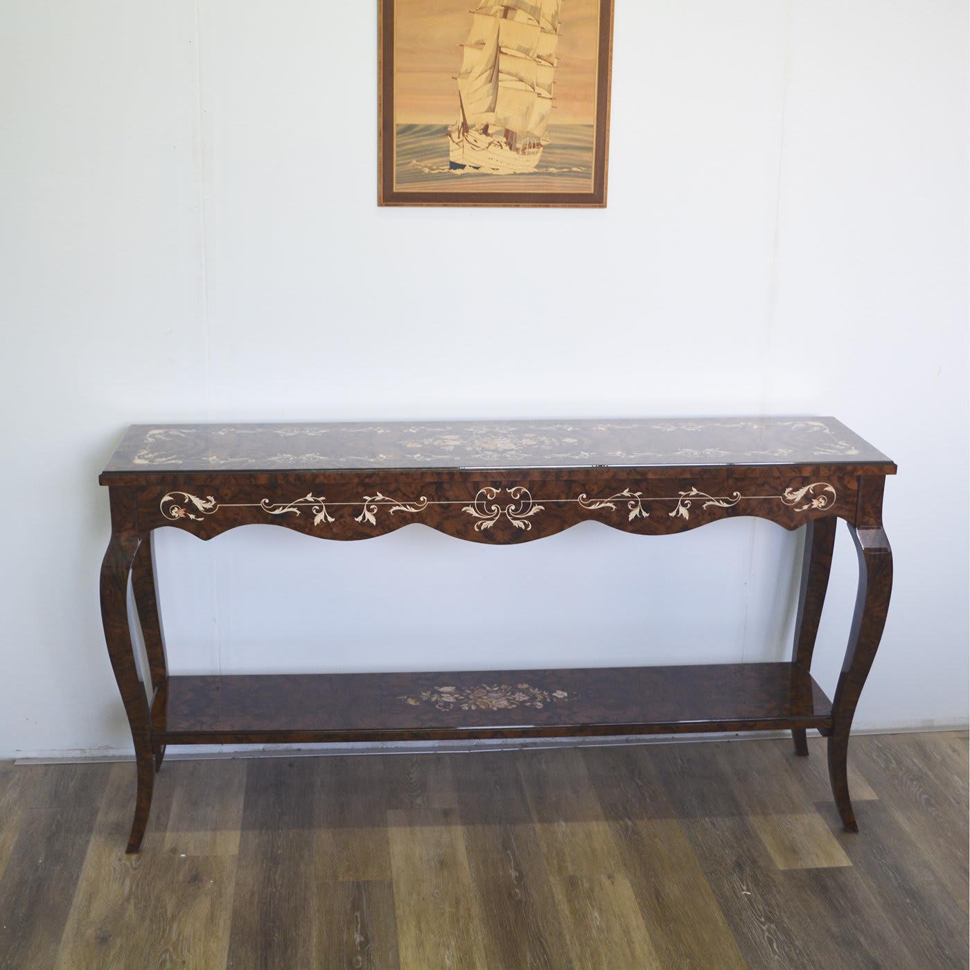 A statement piece of great artistic value, this remarkable console is entirely handcrafted of California walnut with a high-gloss finish to enhance the exquisite natural and dark-stained inlays that decorate the top, lower shelf and scalloped skirt.
