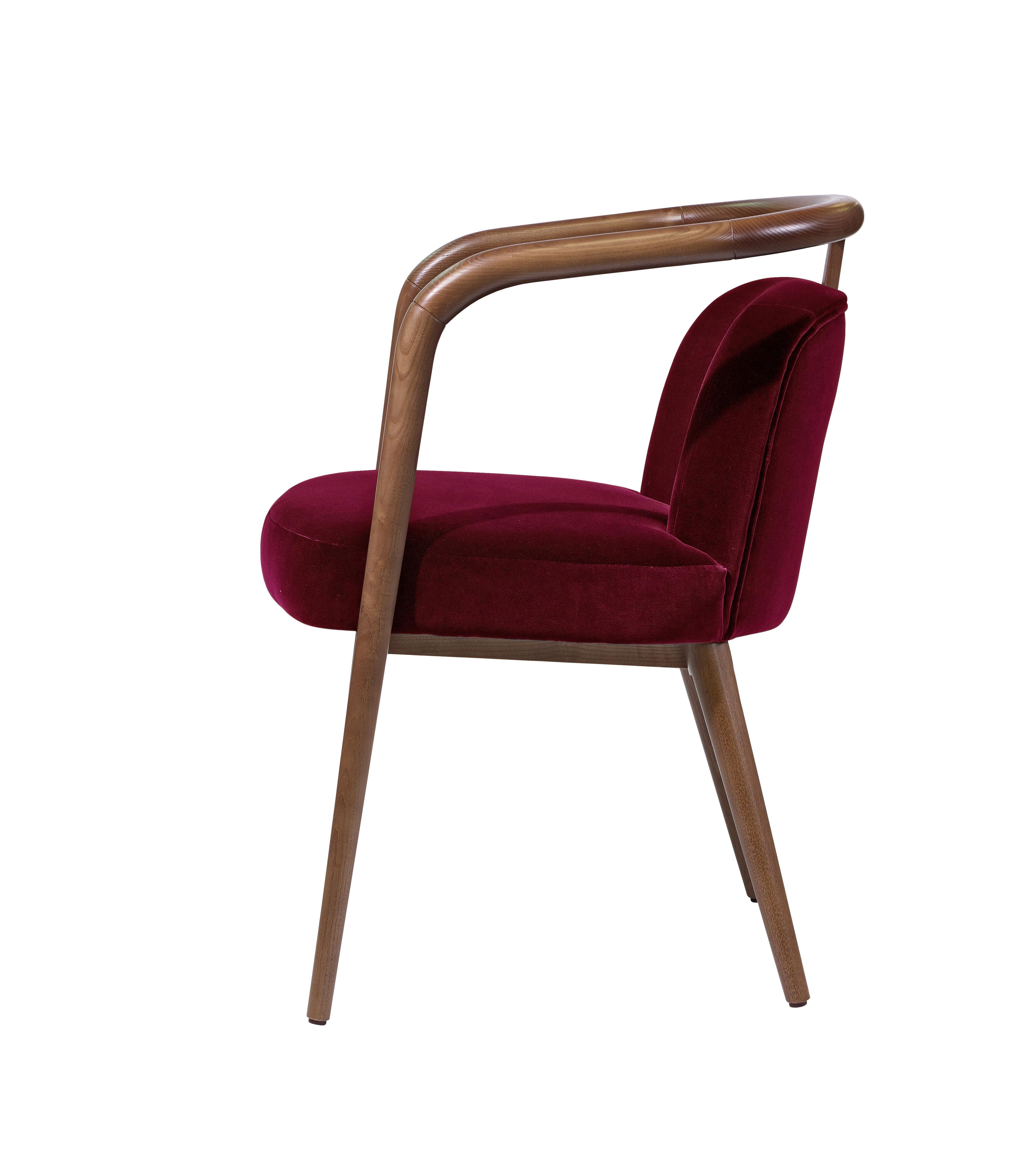 The Essex Armchair combines the warmth of walnut wood with the luxurious feel of velvet upholstery, creating a seating piece that exudes both elegance and comfort. With its clean lines and refined proportions, it brings a sophisticated touch to any