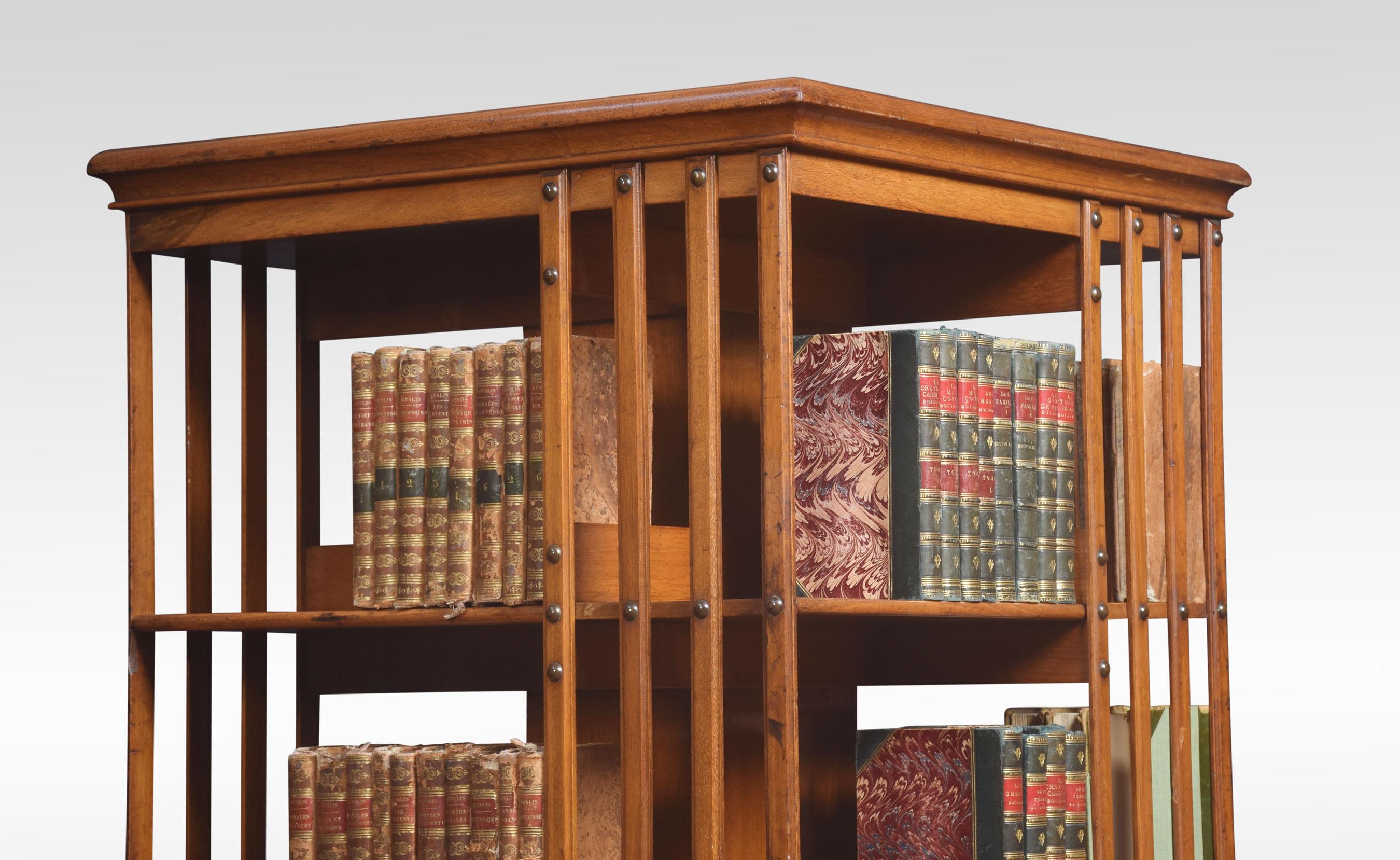 Walnut revolving bookcase the square top above an arrangement off shelves raised up on a cruciform metal base with castors by Maple & Co.
Dimensions
Height 47.5 inches
Width 24 inches
Depth 24 inches.