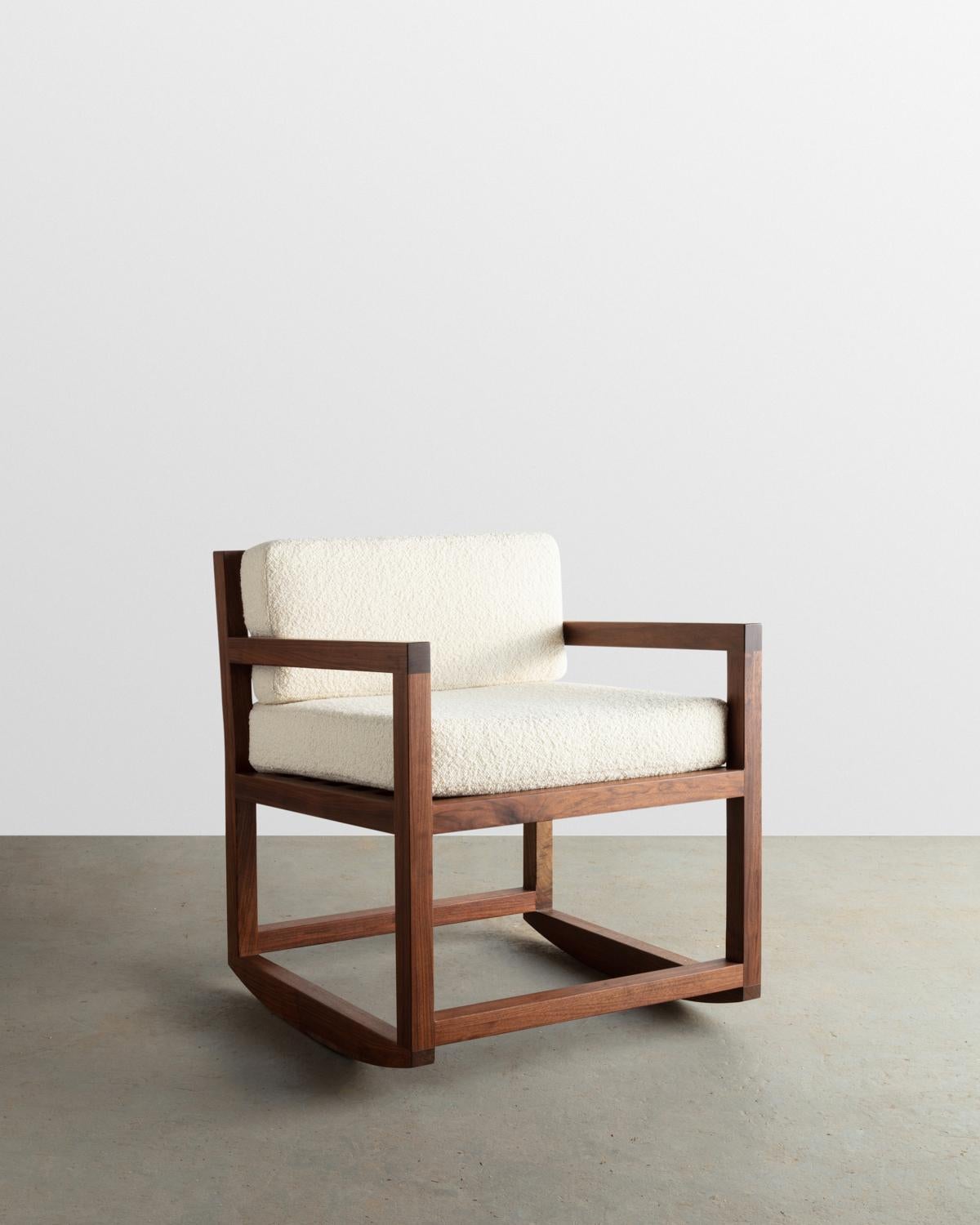 Constructed from solid Walnut this Rocker-lounge chair is designed and built to last. Its seat and backrest are upholstered with a natural Bouclé fabric.