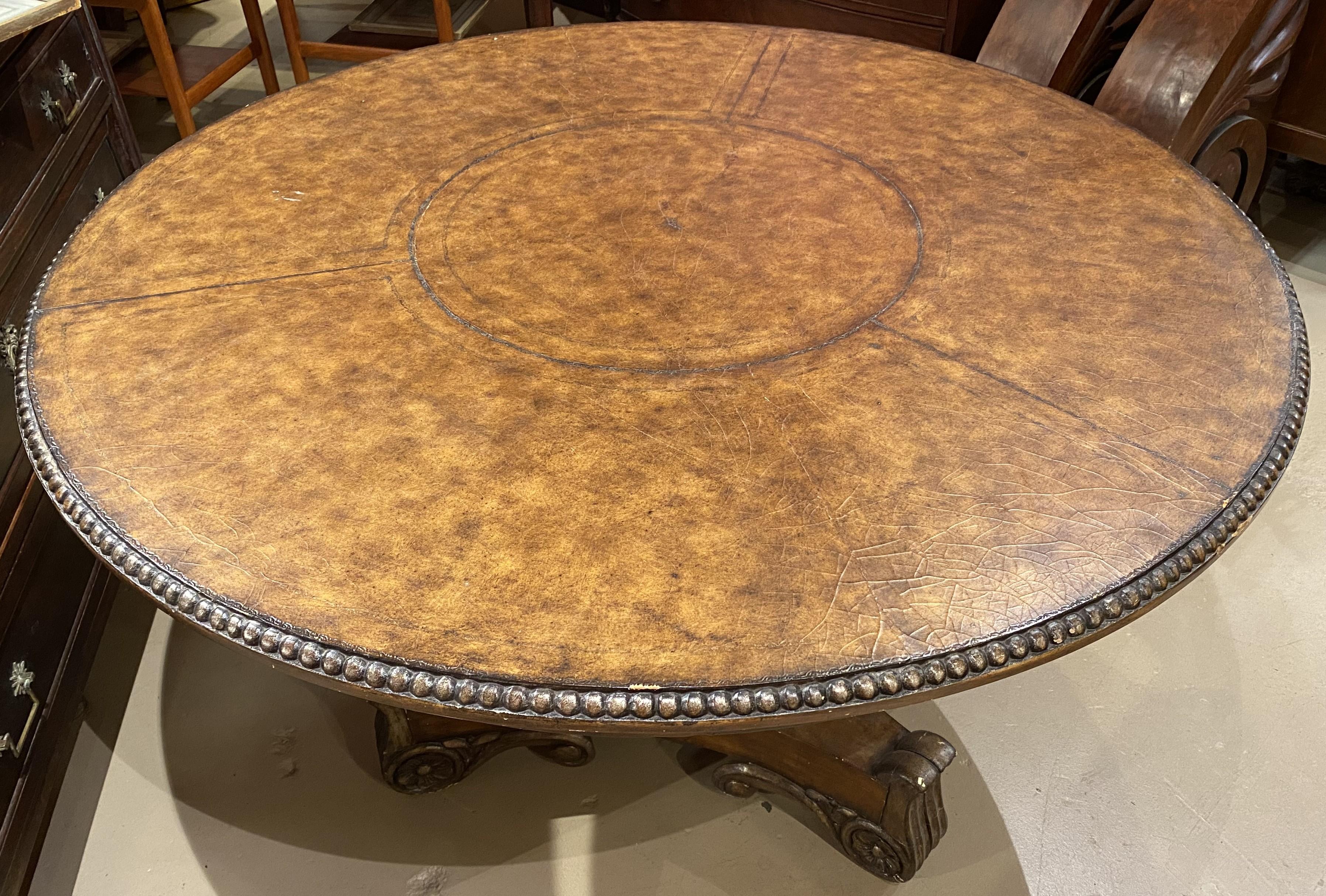 A nice example of a walnut polychromed round center table with leather top in a craquelure finish with beaded edge in the classical form, with center round pedestal supported by three scroll carved feet. Probably English in origin, dating to the