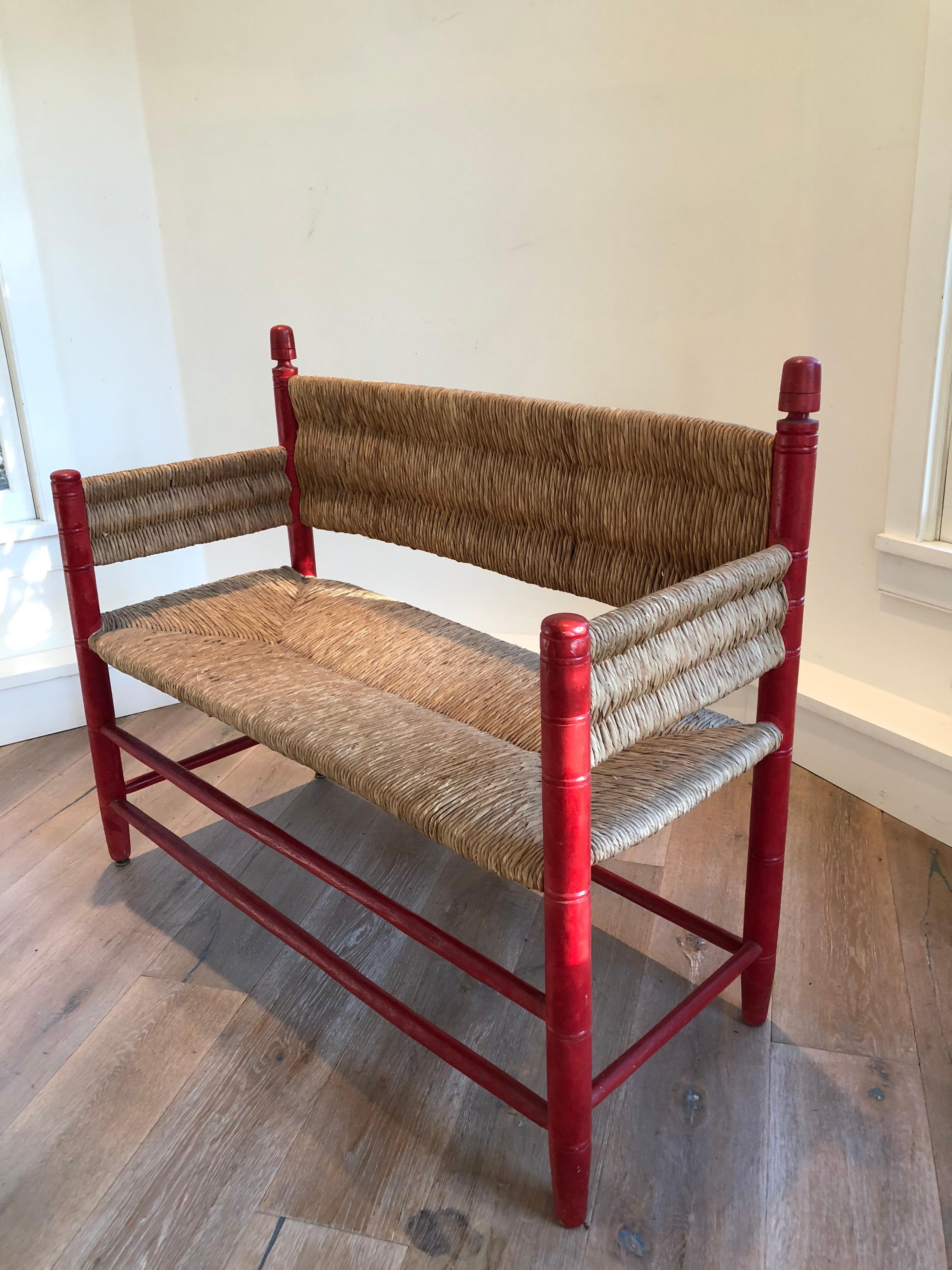 A walnut rush seat bench or settee with red painted frame. Sturdy construction and comfortable.