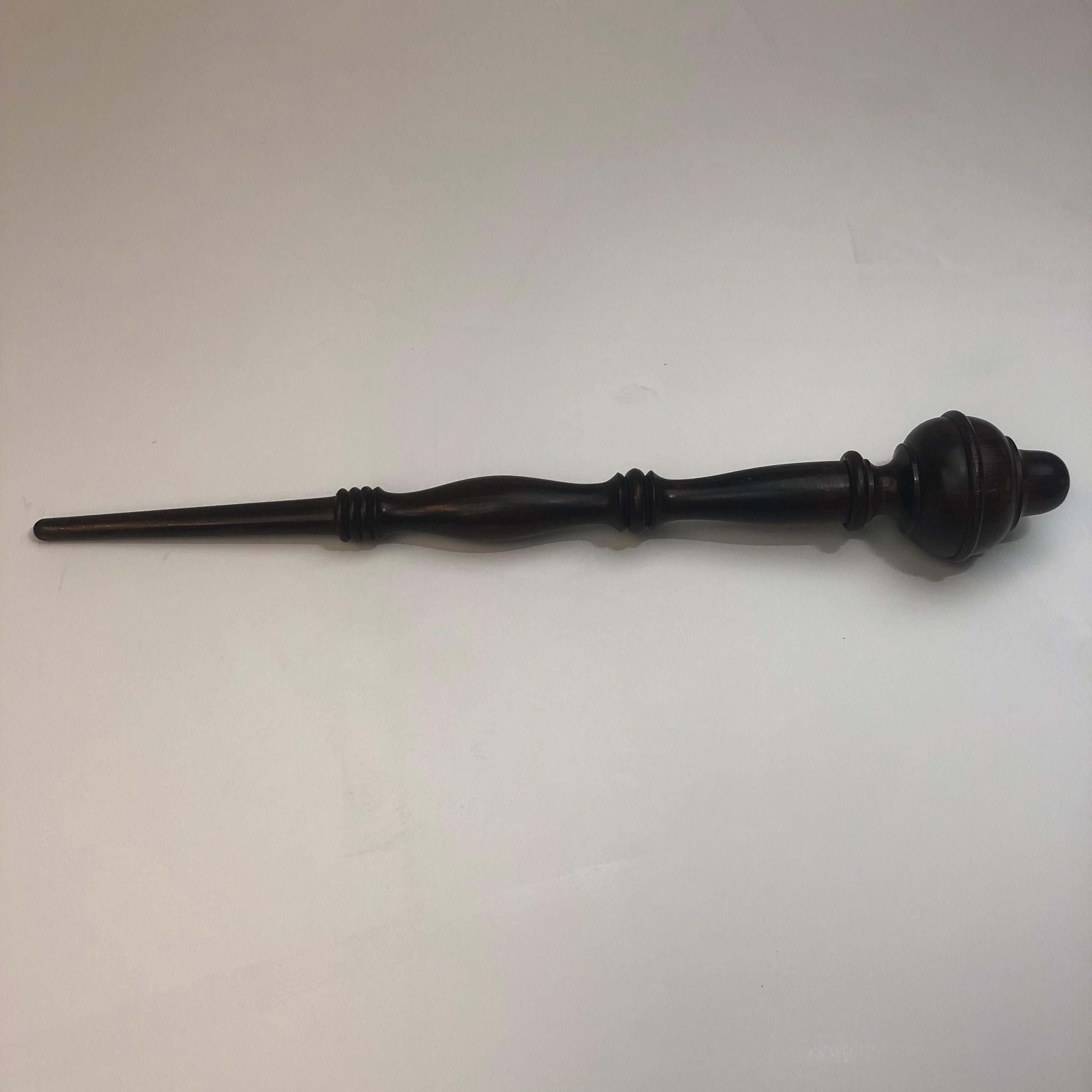 A complicated and finely turned and finished vintage dark walnut scepter/wand produced most likely to showcase the variety of radius arcs and knurling's the wood shop was capable of producing. This is a two piece production consisting of the turned