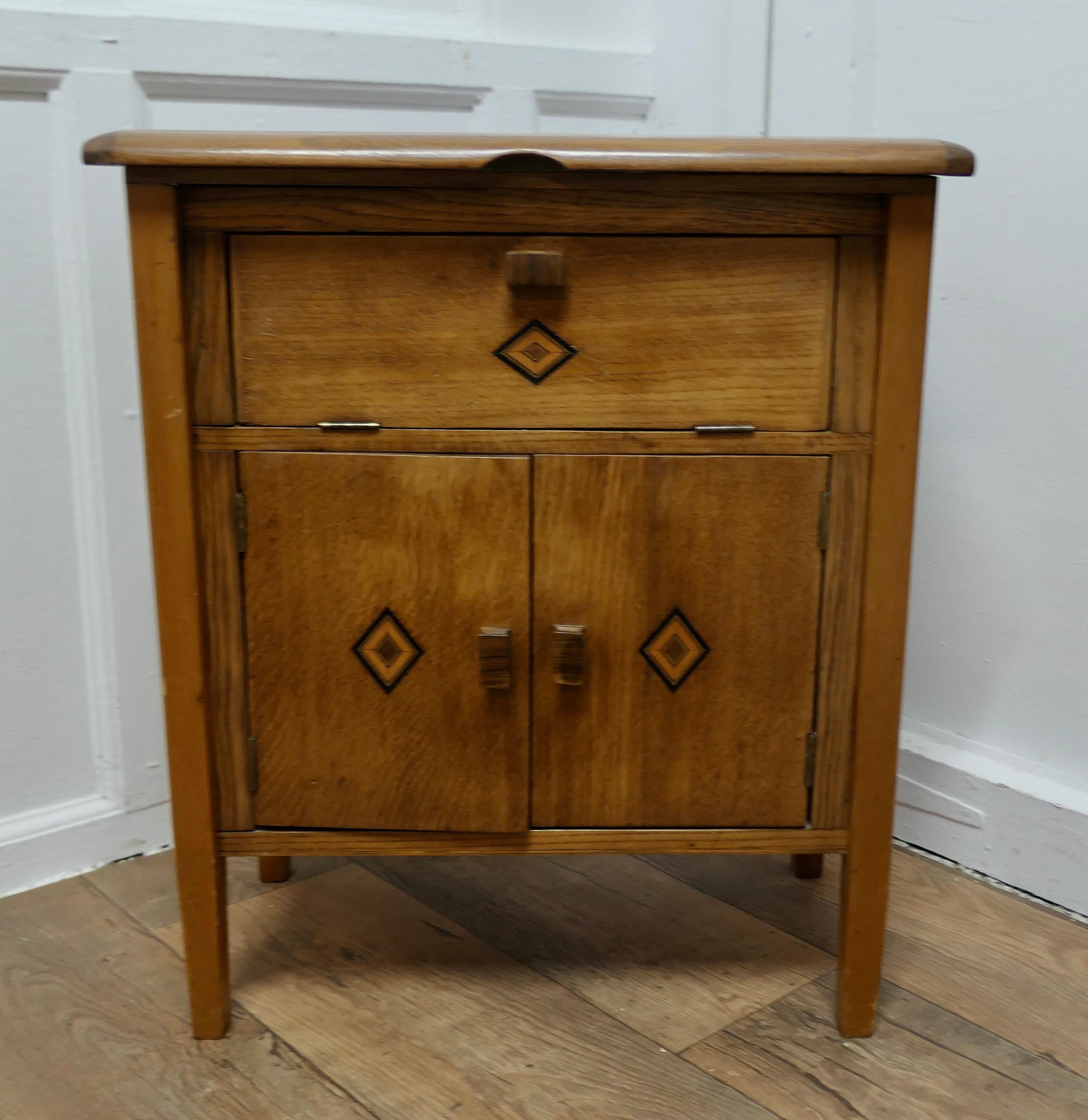 Walnut Sewing Cabinet

This is a good and useful little cupboard which has doors to the front, above this there is a cotton reel fall front compartment and the top lifts up to access the rest of the storage
The top opening storage has a pin cushion