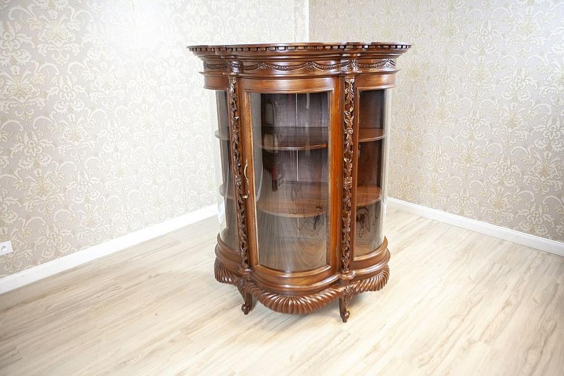 Brown Walnut Showcase from the 2nd Half of the 20th Century

We present you a semi-rounded, single-leaf showcase with a highly advanced, solid cornice which is decorated with floral carved patterns. The whole is supported on four delicately bent