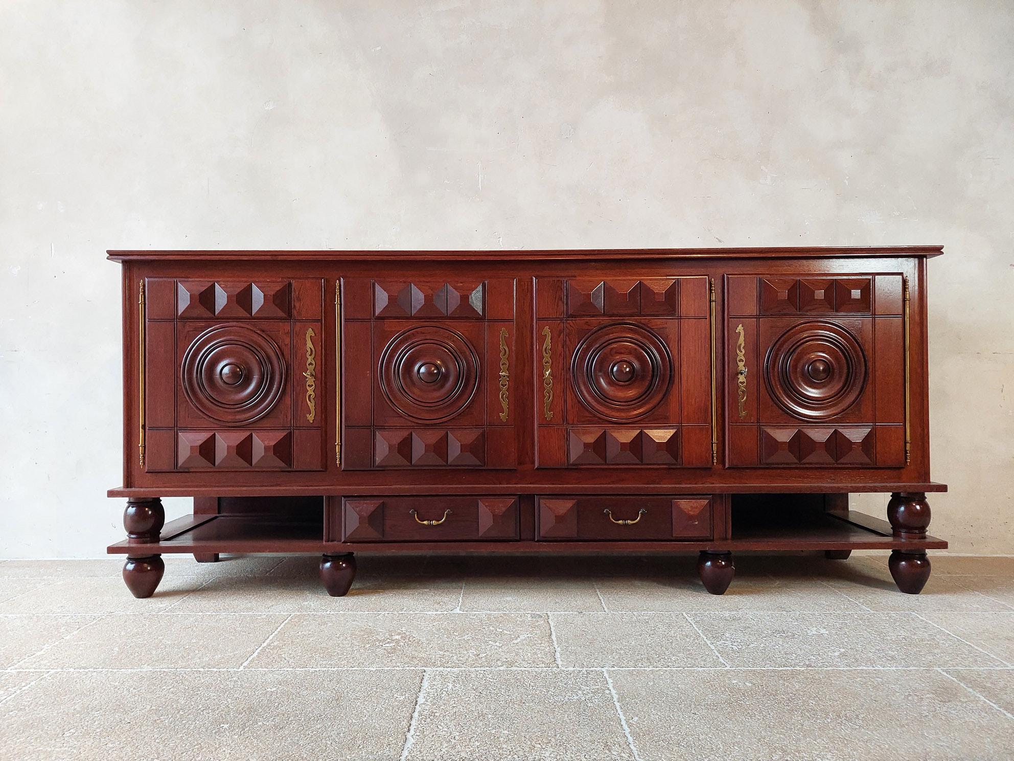 Beautiful large sideboard by Charles Dudouyt in Dark brown Walnut with a polished finish. Made in the 1940s. Four doors and two drawers with the typical geometrical shapes by Dudouyt. Style: Art Deco, early brutalist.

Dimensions: H 101 x W 240 x