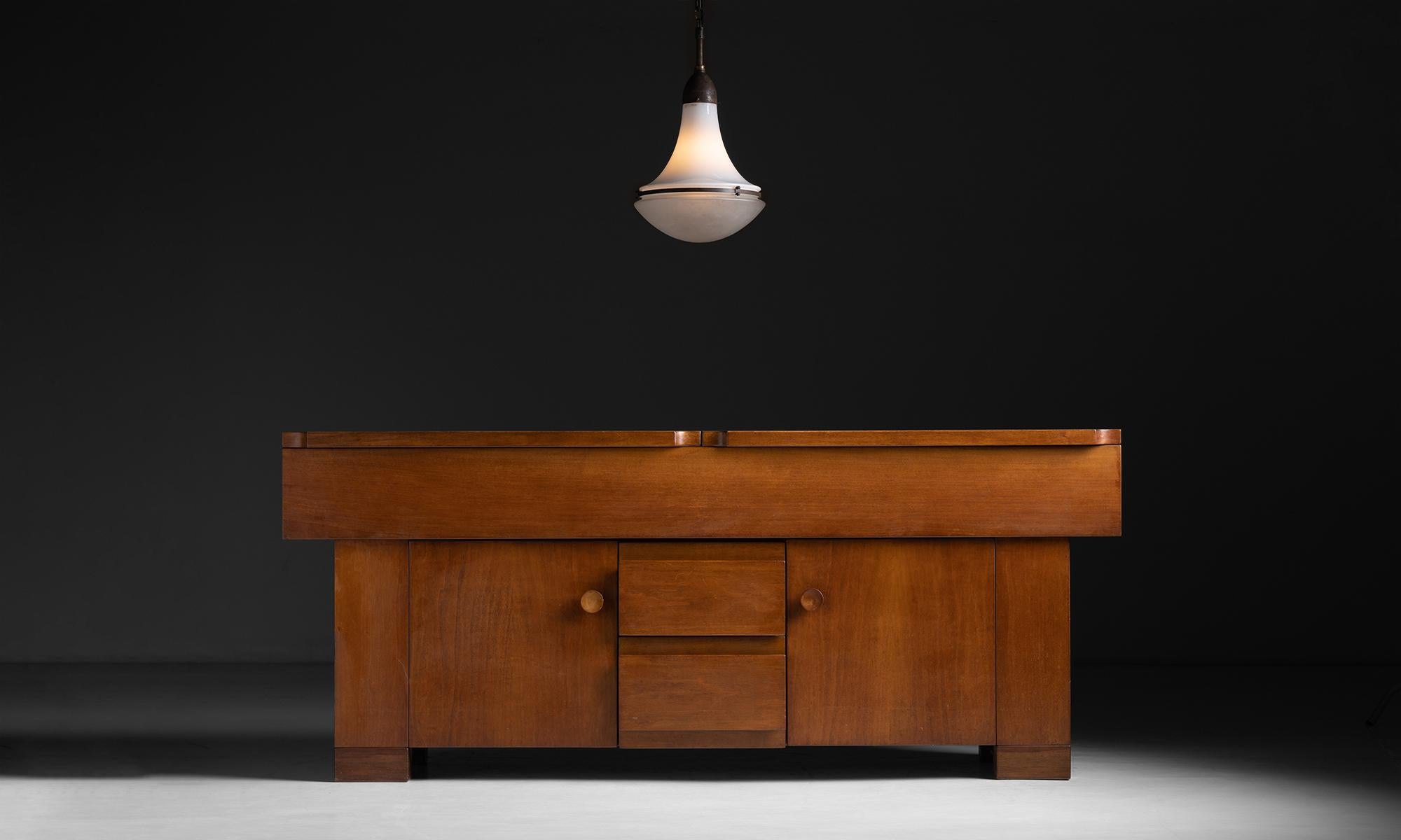 Walnut Sideboard by Giovanni Michelucci, Italy circa 1965

Designed for Poltronova with beautiful architectural lines. Two cupboards, two drawers and a hinged top, etched with the designers signature.

Measures 78.5”L x 20.5”d x 33”h.