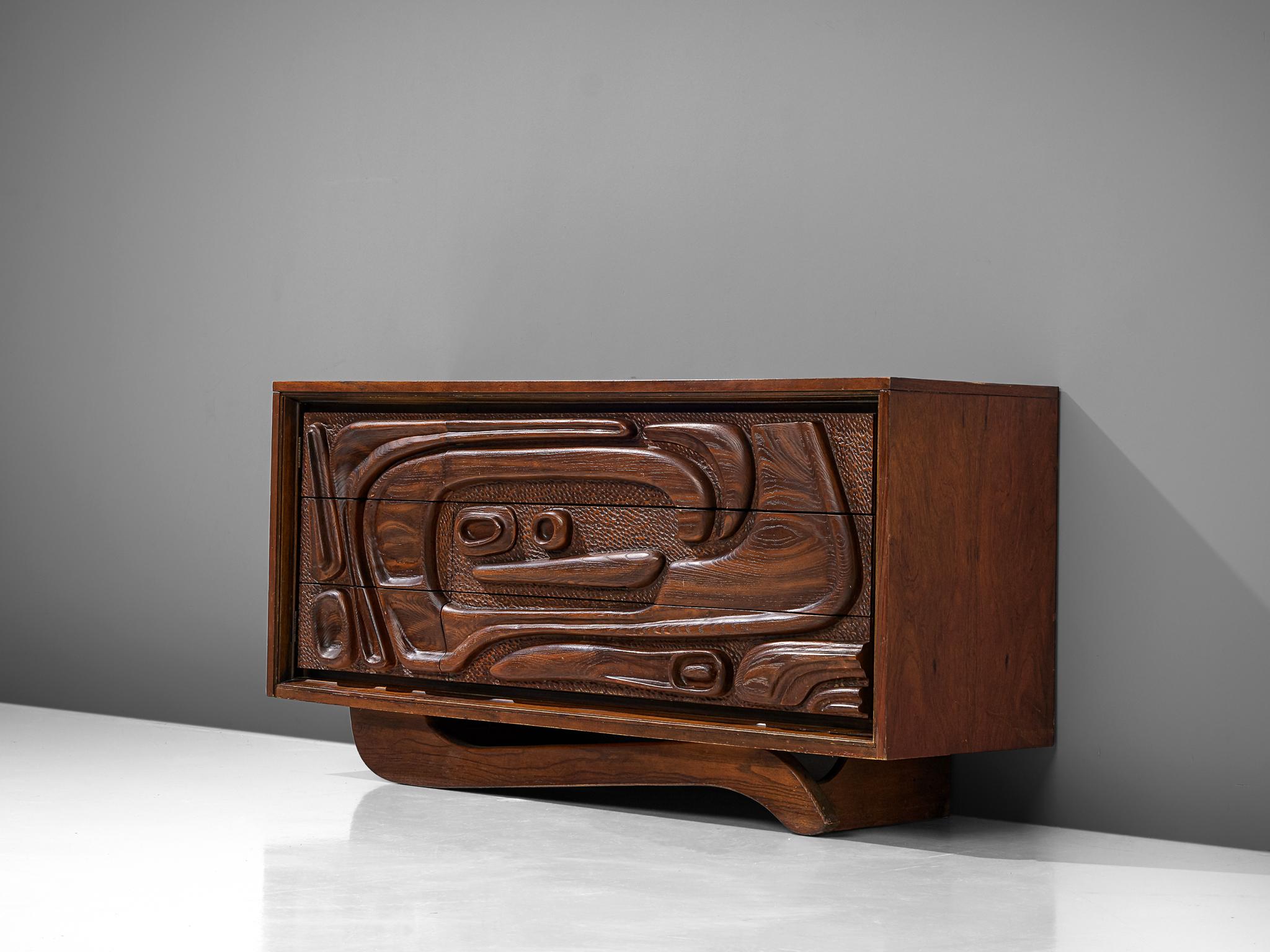 Pulaski Furniture Corporation, attributed to Witco, sideboard, walnut and molded plastic, United States, 1960s

A carved cabinet in walnut by Pulaski Furniture Corporation. The wildly carved front shows an organic, tribal inspired structure. The