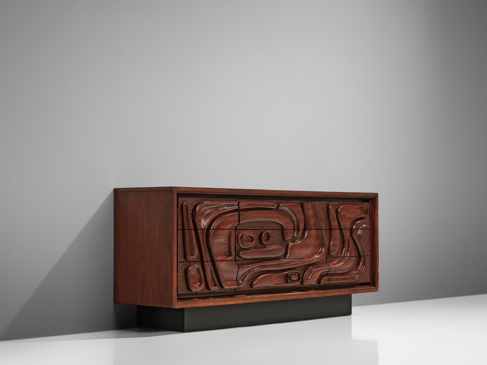 Pulaski Furniture Corporation, attributed to Witco, sideboard, walnut, United States, 1970s

A carved cabinet in walnut by Pulaski Furniture Corporation. The wildly carved front shows an organic, tribal inspired structure. The sideboard consists of