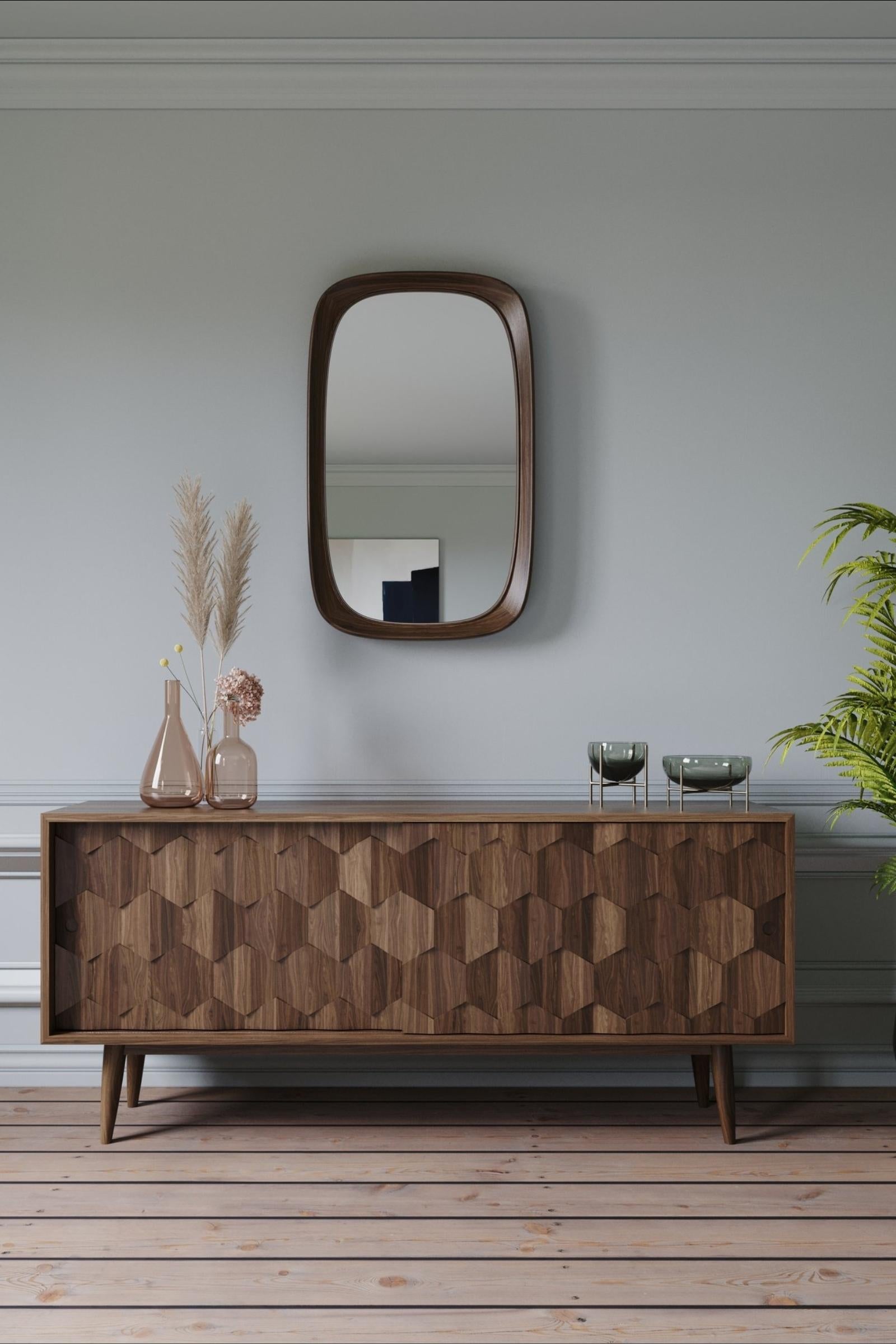 Crafted from high-quality and certified materials, his gorgeous sculptural solid Walnut sideboard emphasizes the traditional joinery techniques.

With the structure and interiors in 100% solid wood, this is a rectangular sideboard with a unique