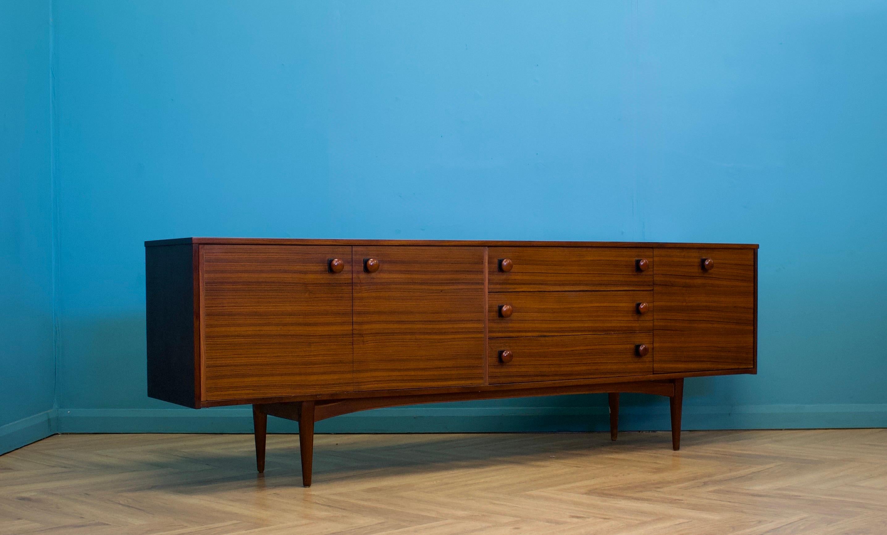 A mid century walnut sideboard retailed by The Grange, London, circa 1960s




Featuring a cupboards - with shelf, three drawers and pull down drinks cabinet

