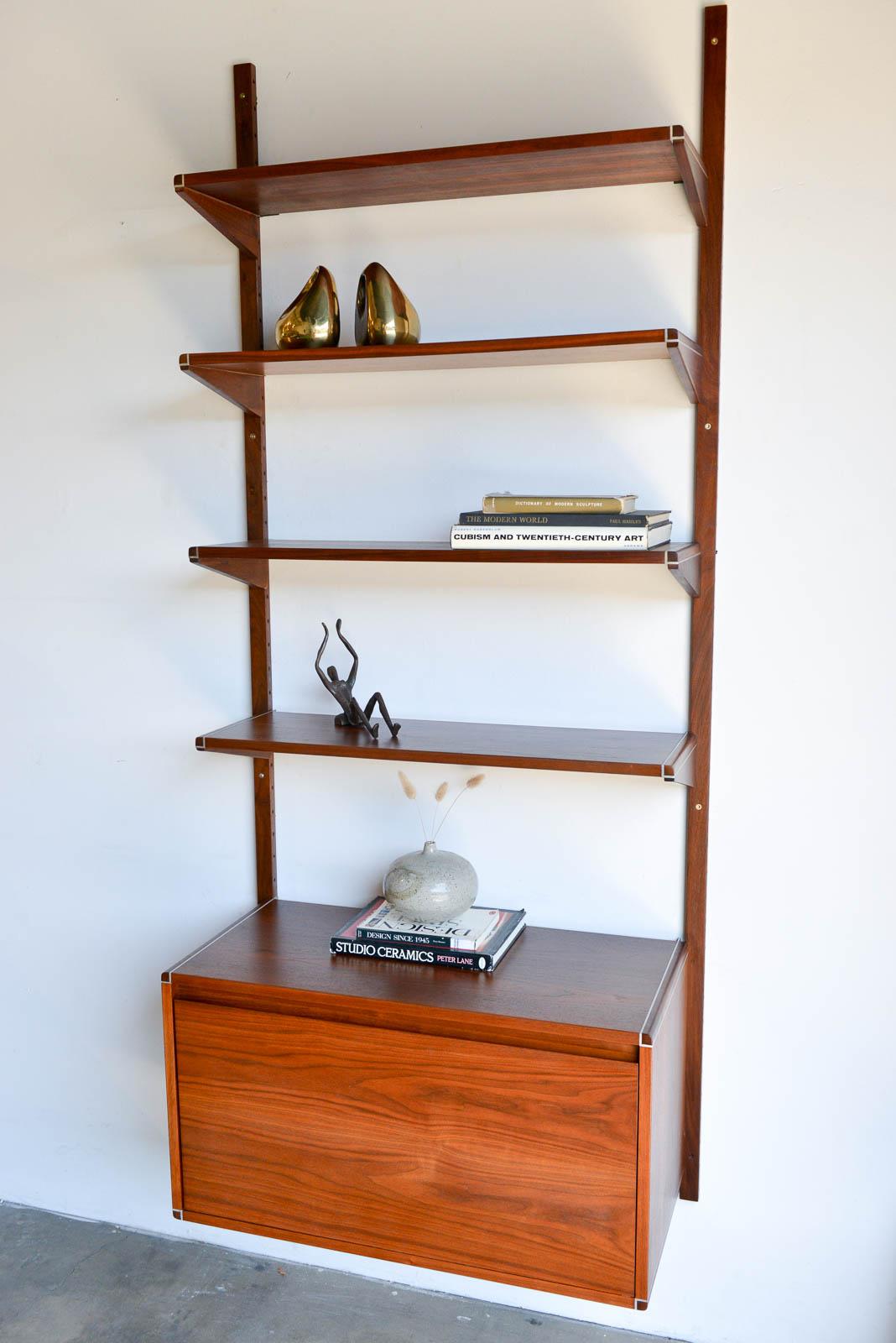 Walnut single section wall or shelving unit by Barzilay, ca. 1970. Beautiful, high quality walnut poles and shelves. Cabinet has a fold down front that can be used as a desk or a liquor cabinet, it is lined for waterproofing. Inside is a small