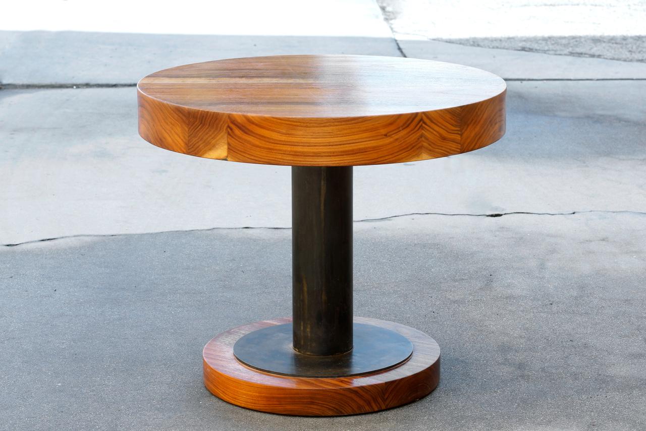 This gorgeous wood and steel table is composed of a lacquered 3