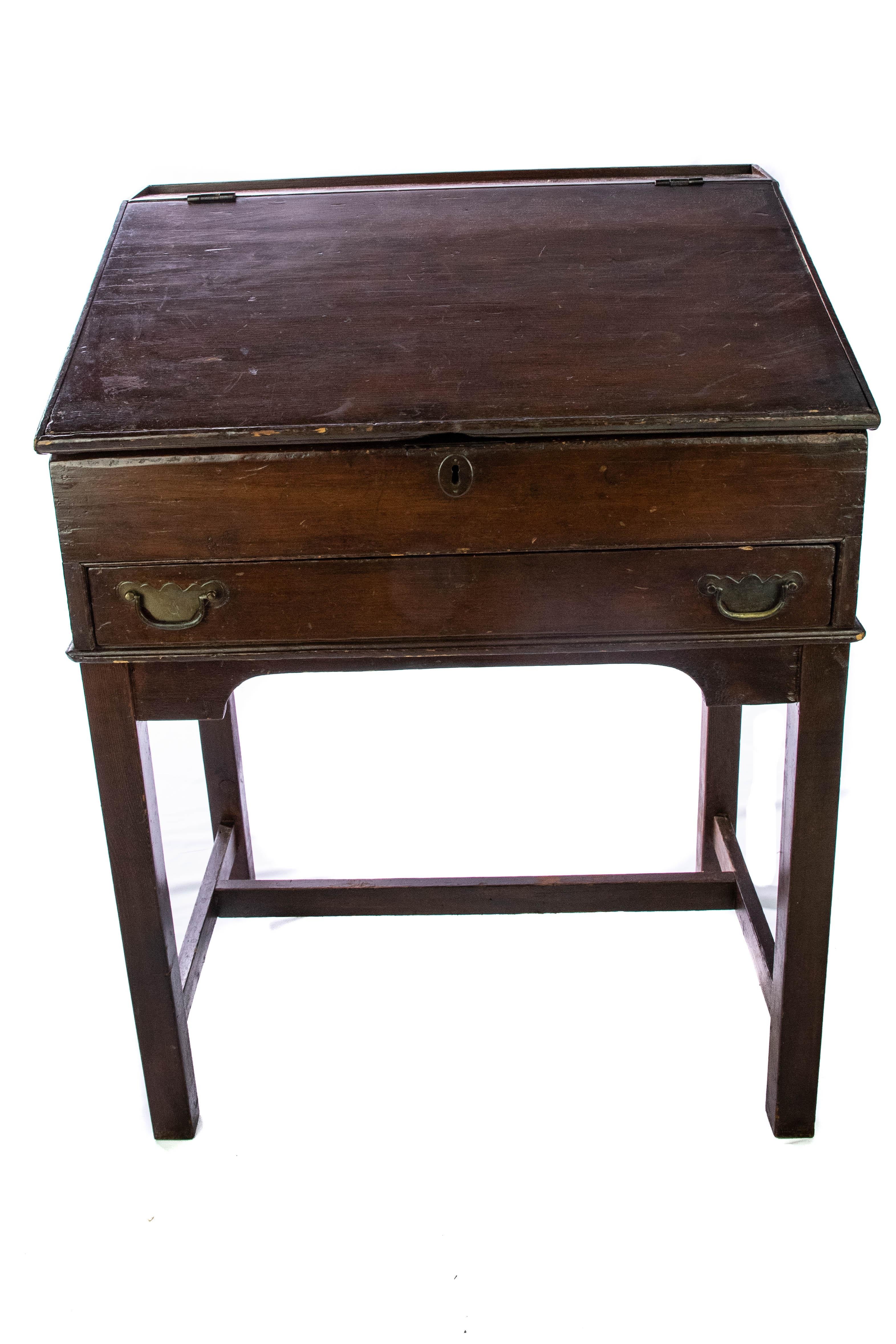 Up for your consideration is this gorgeous 19th century walnut slant top writing desk. This deep toned stained walnut desk will please the eye for years to come. Featuring a slant top that is hinged for writing. When open the desk features many
