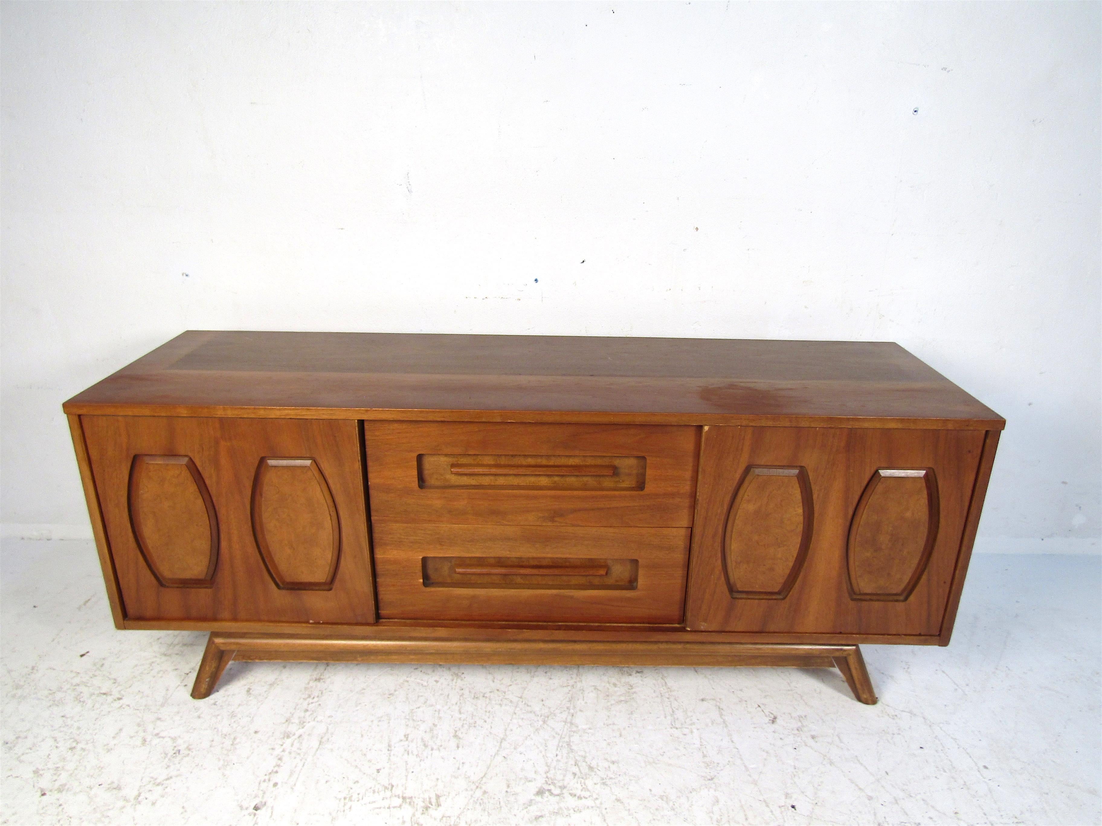 Beautiful dark wood serving credenza will fit perfectly in any dining room set up. With clean lines and a Classic style, this piece is sure to please. Ample storage and easy access drawers make this piece both beautiful and functional. Please