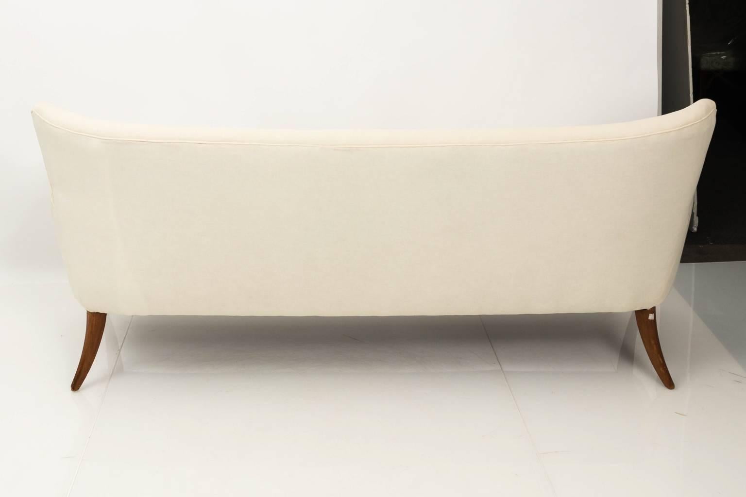 1950s re-upholstered walnut sofa attributed to Ersnt Schwadron, reupholstered in muslin fabric.