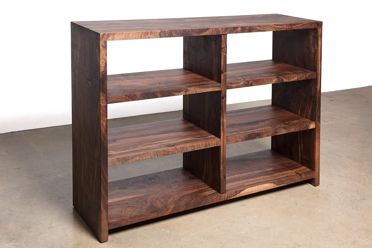 Precision joinery and swirling wood grain of the Walker Bookshelf draw the eye through every angle of these handcrafted, casework shelves. Add a warm touch of natural elegance to you home as you store books in the library or office, towels and
