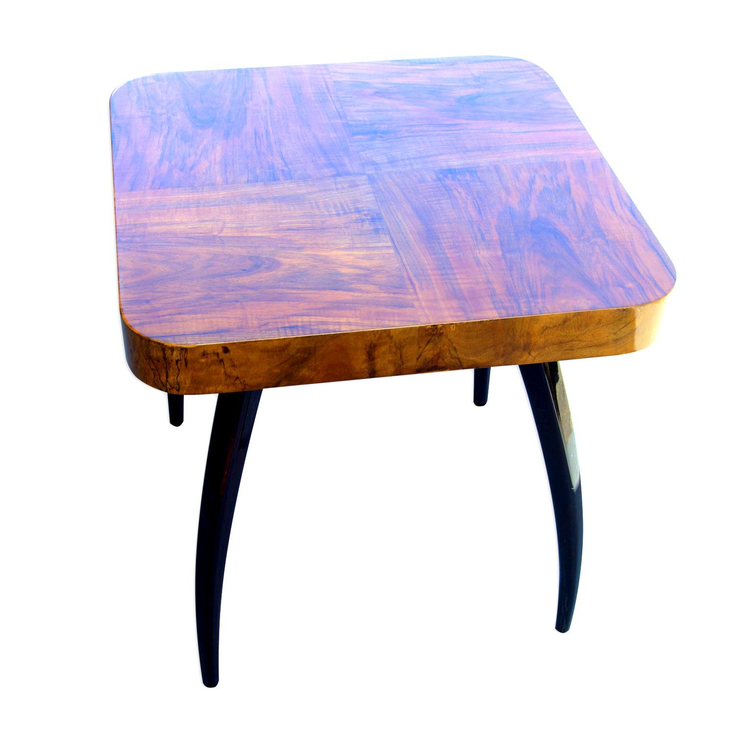 This walnut table called spider was designed by the world famous architect Jindrich Halabala under catalog No. H-259 in the 1930s and produced in the 1950s. Unique style of this table is recognized all over the world. The table stands on four legs