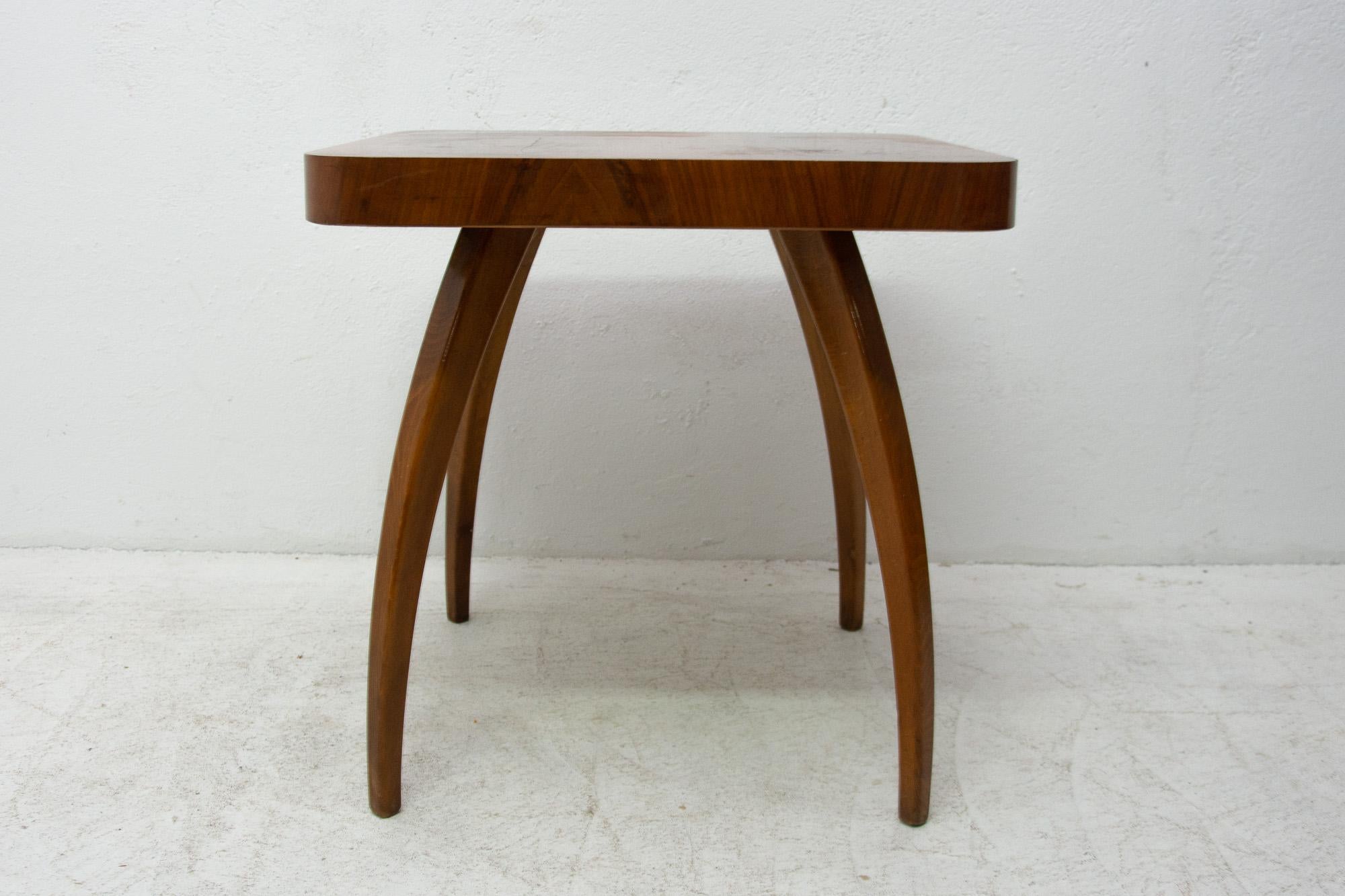 This walnut table called spider was designed by the world famous architect Jindrich Halabala under catalog no. H-259 in the 1930s and produced in the 1950s. Unique style of this table is recognized all-over the world. The table stands on four legs