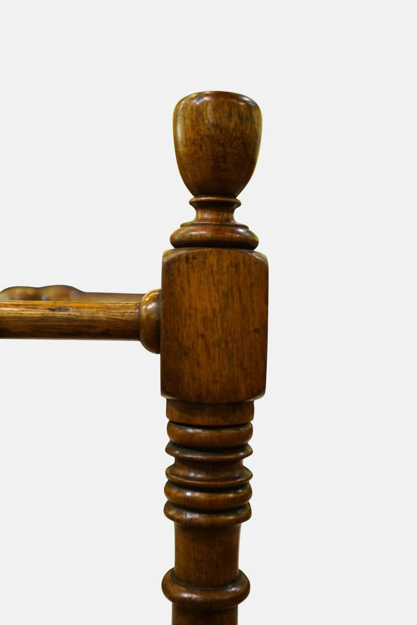 Walnut stick stand in the manner of Shoolbred & Co.

12 bays, bobbin turned divisions, and metal tray,

circa 1880.
 