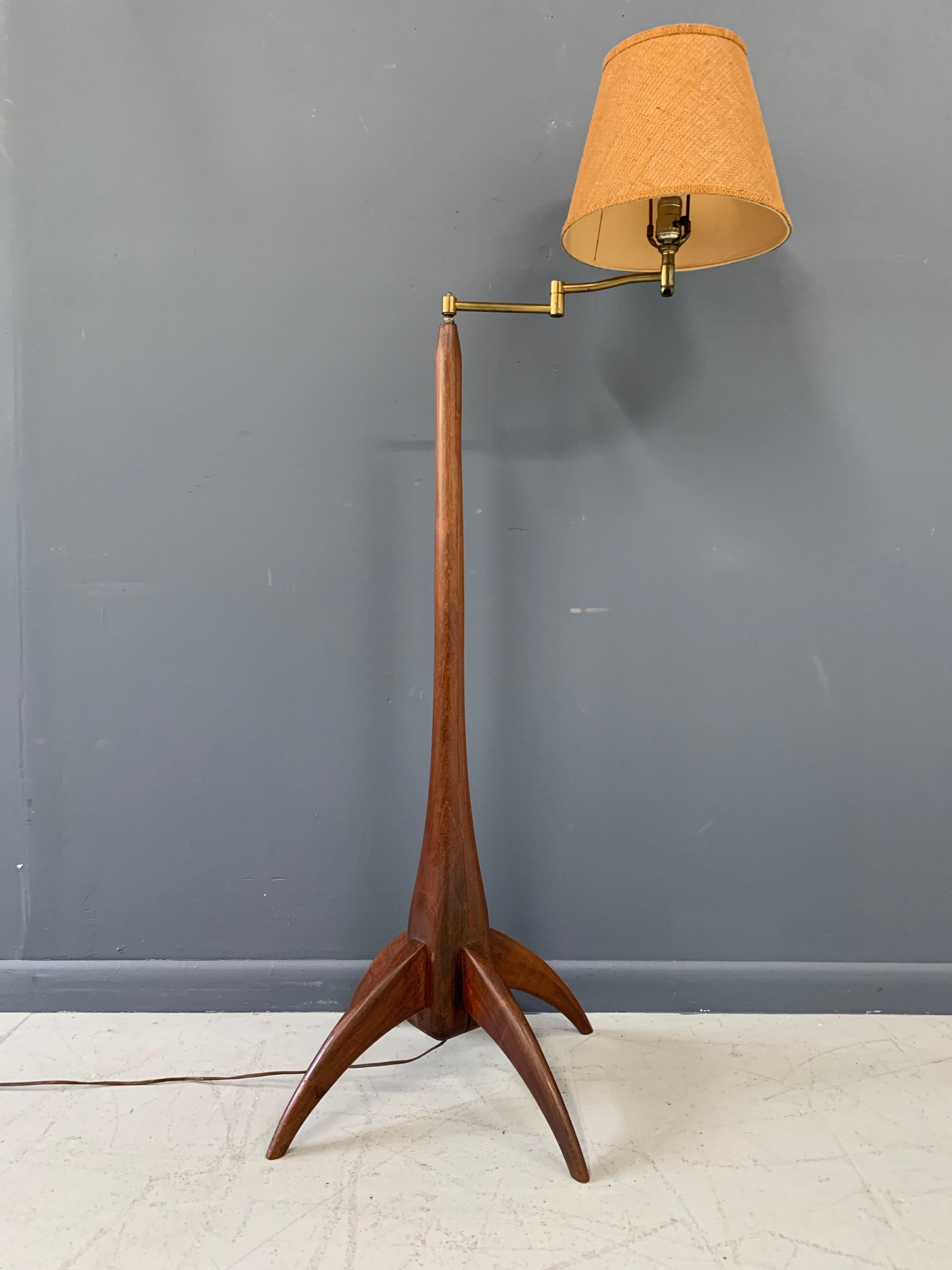 This beautiful example of studio furniture has a graceful body made of two pieces of lovely figured walnut and four legs all hand carved. The carving is very apparent in this piece as you will see in the pictures.

This floor lamp was purchased in