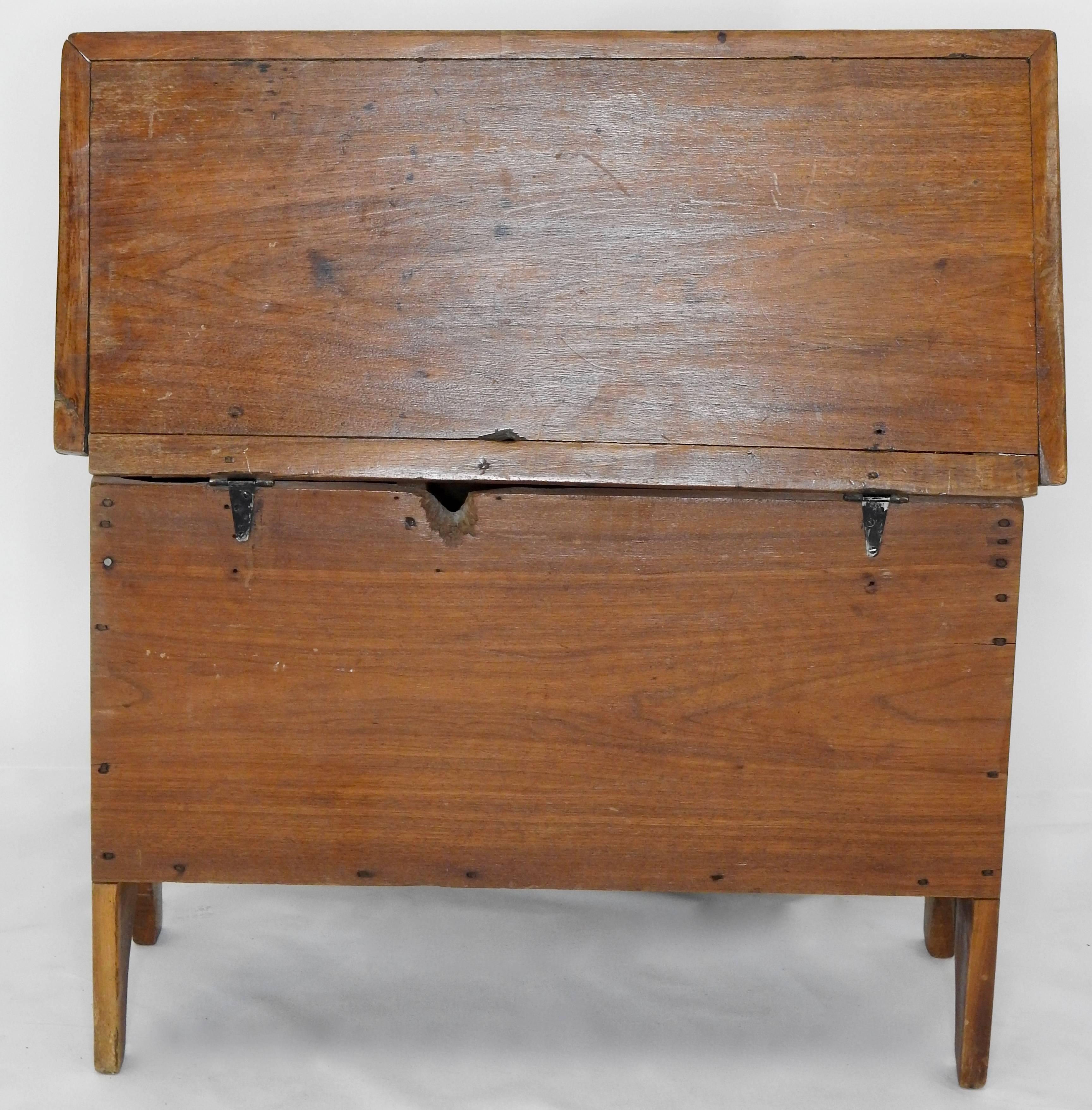 This is a Classic 19th century walnut sugar trunk with lift top lid. This simple yet stately piece had a warm natural tone. It sits on a bracket type leg that is formed by two semicircles on either side. It does not have the lock mechanism.