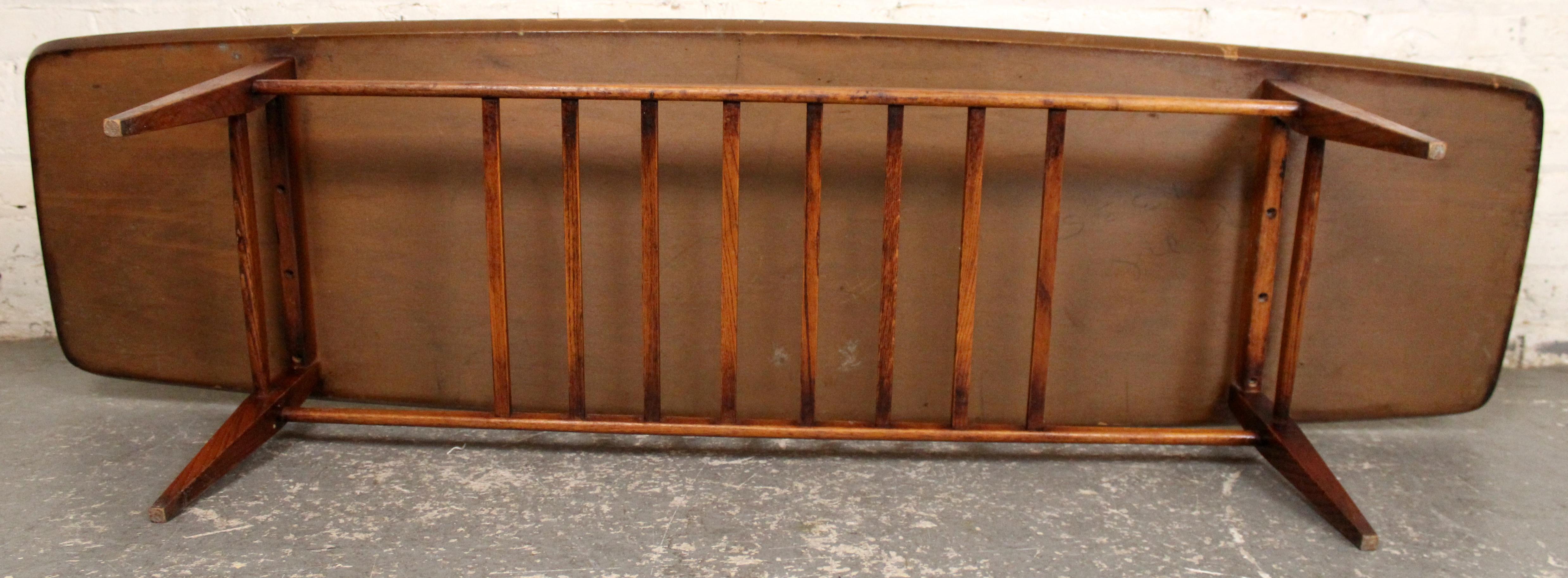 Mid-Century Modern Walnut Surfboard Coffee Table with Spindled Shelf For Sale