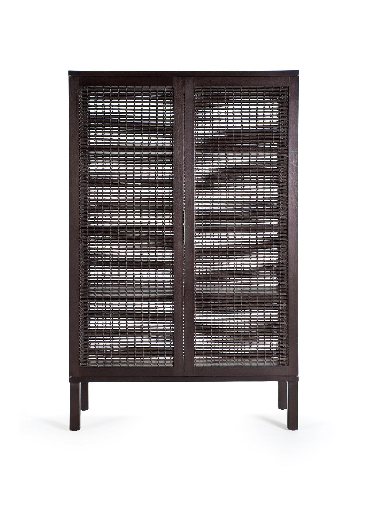 Walnut Suzy Wong cabinet by Kenneth Cobonpue.
Materials: Lampakanai, rattan, walnut. 
Also available in maple.
Dimensions: 50 cm x 100 cm x H 160 cm

Woven panels create a feeling of intimacy as you and your guests indulge in conversation or