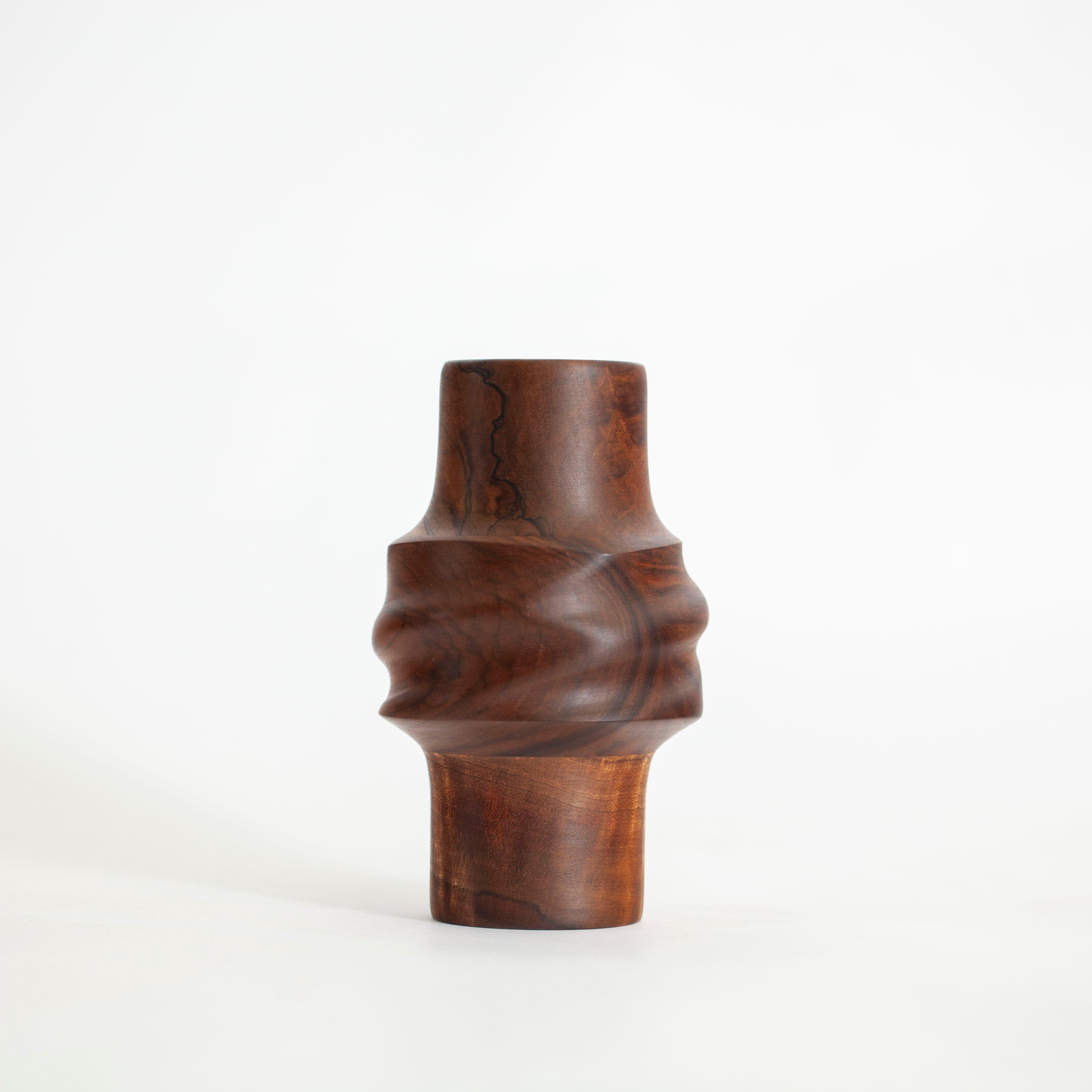 Svitok vase in walnut wood from downed trees from Street Tree Revival, Anaheim, CA. Inspired by the knots and twists in trees with the likeness of a fabric knot. The irregular shapes and folds in the wood encourage curiosity, just as a walk outside,