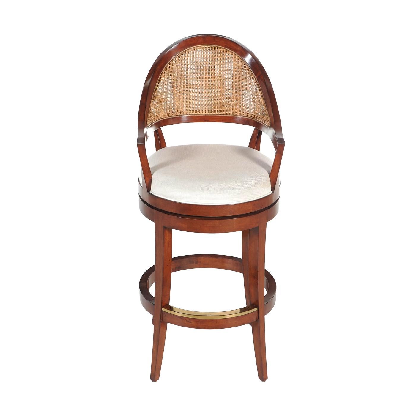 Featuring a rich walnut frame, this stool is designed with 3/4 swivel functionality for effortless movement. The cane backing adds natural texture and charm, while the neutral linen upholstery provides a soft, comfortable seating experience.

Ideal