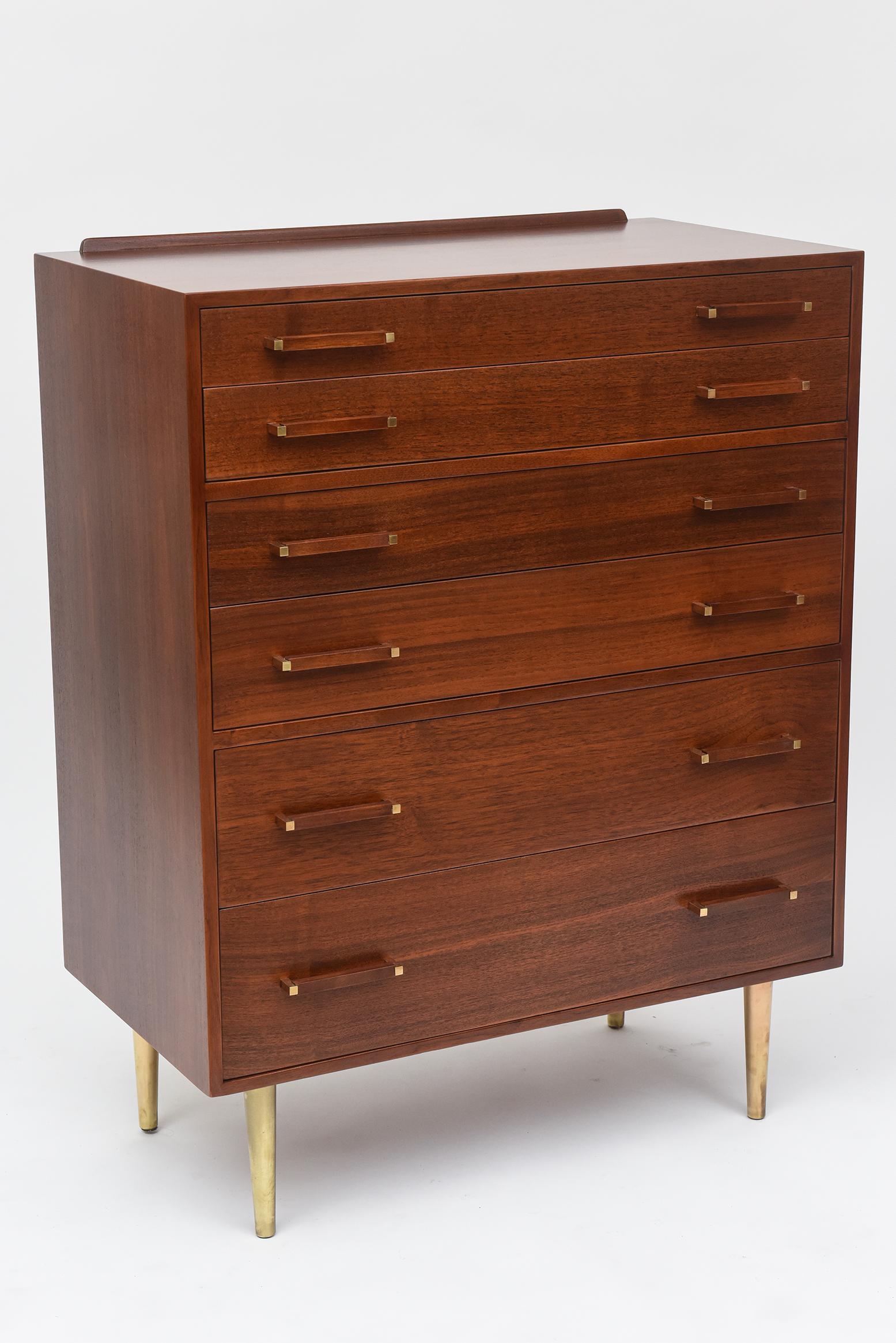 Designed by Edward Wormley, this exceptional 1950s walnut tall dresser, with its solid brass legs and polished handle details, possesses all the style and quality craftsmanship for which Dunbar is known and prized today.