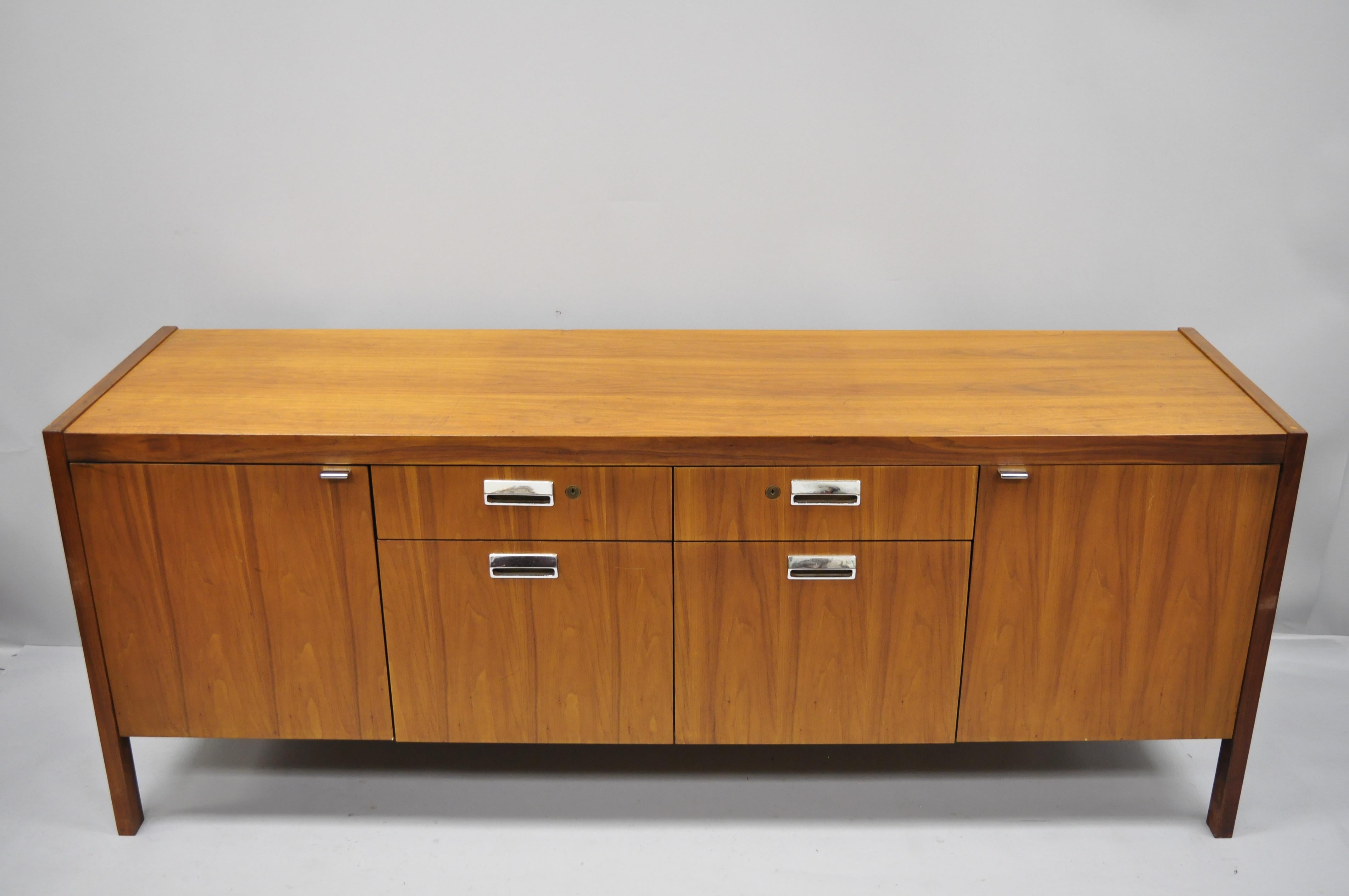 Mid-Century Modern walnut and teak veneer Knoll style credenza cabinet attributed to Stow Davis. Item features beautiful wood grain, finished back, 2 swing doors, no key, but unlocked, 4 drawers, 2 adjustable shelves, clean modernist lines, circa