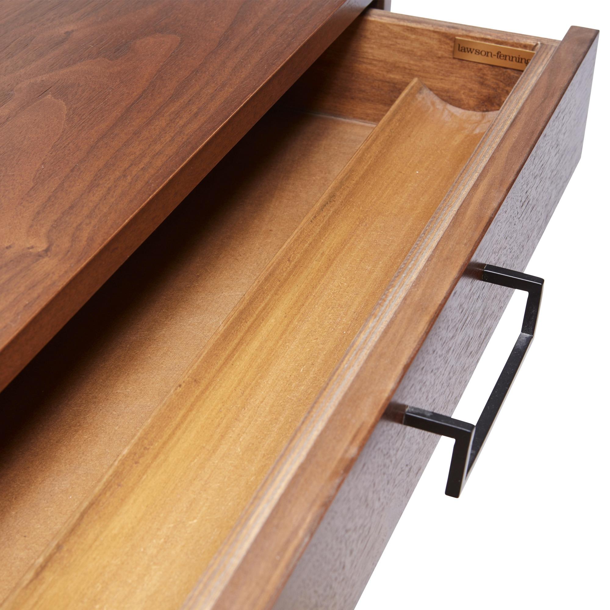 The thin frame desk has two drawers, each with its own pencil tray and features a plated steel base and handles. Available in American walnut or white oak. 


 